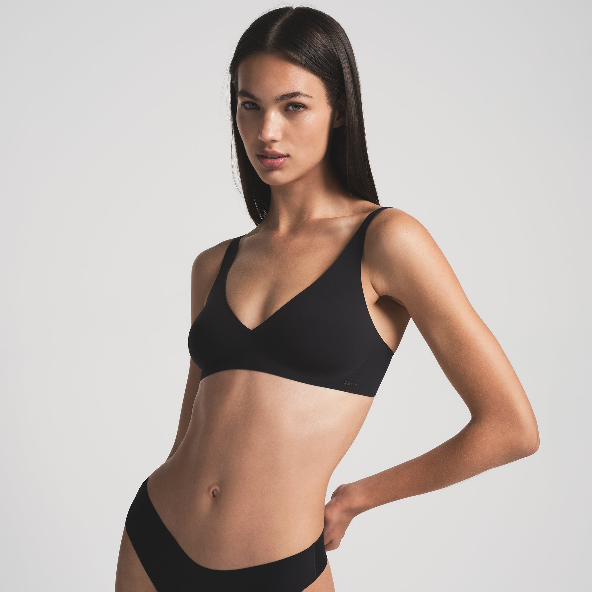 NAKED PLUNGE BRA WORN BY A MODEL IN FRONT VIEW