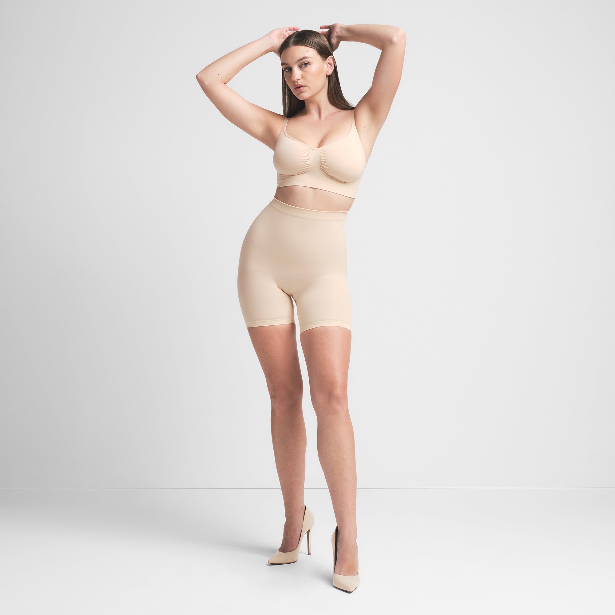 SEAMLESS SCULPT BRALETTE | SAND ON A MODEL FRONT VIEW