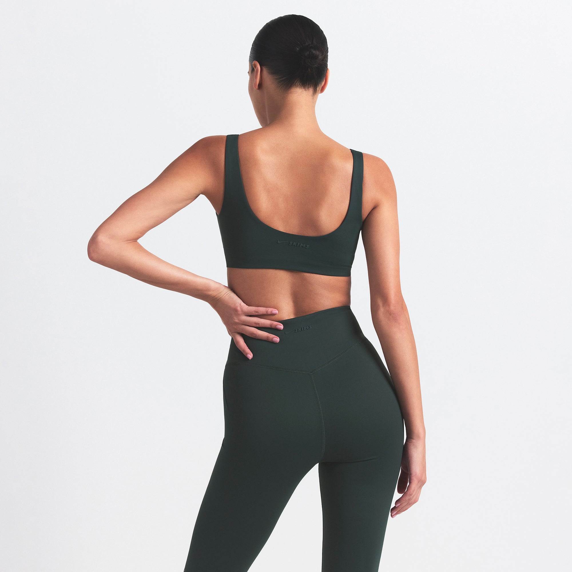 NikeSKIMS MATTE SCOOP NECK BRA | DARK TEAL ON A MODEL SIDE VIEW @ | FOCUS: 0.0, 1.0, 0.9