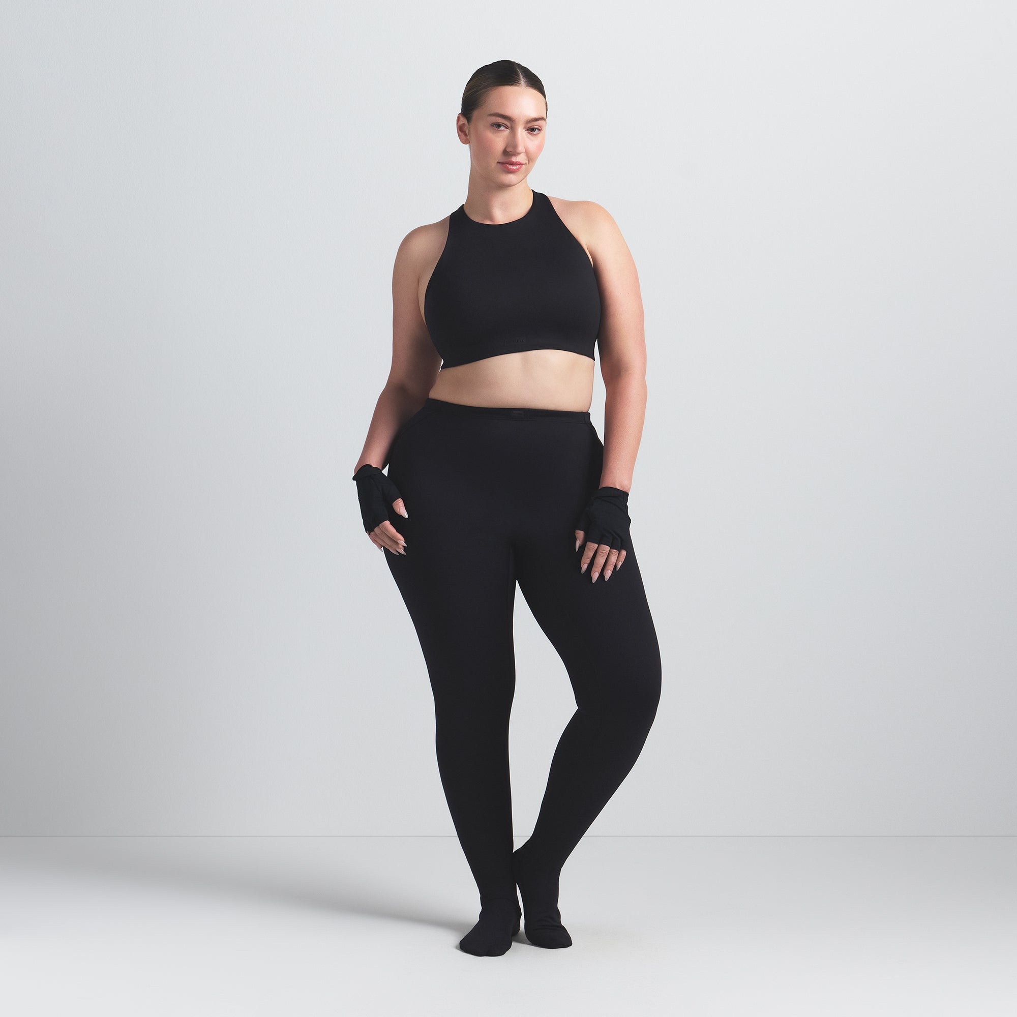 NikeSKIMS MATTE HIGH NECK BRA | OBSIDIAN ON A MODEL FRONT VIEW @ | FOCUS: 0.0, 1.0, 0.9