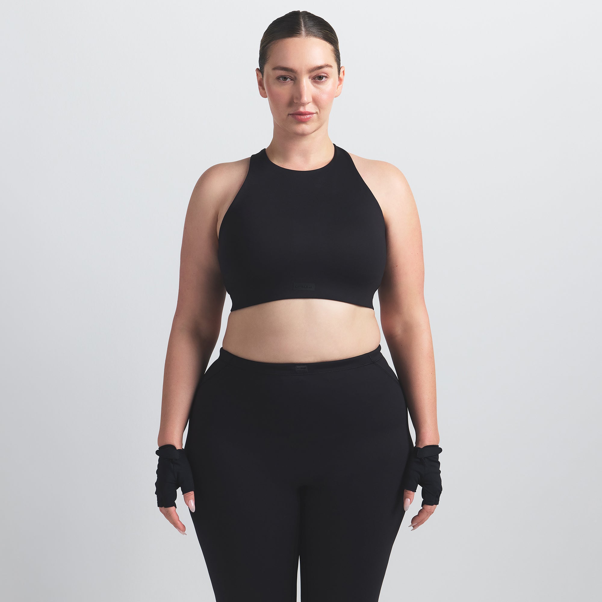 NikeSKIMS MATTE HIGH NECK BRA | OBSIDIAN ON A MODEL FRONT VIEW @ | FOCUS: 0.0, 1.0, 0.9