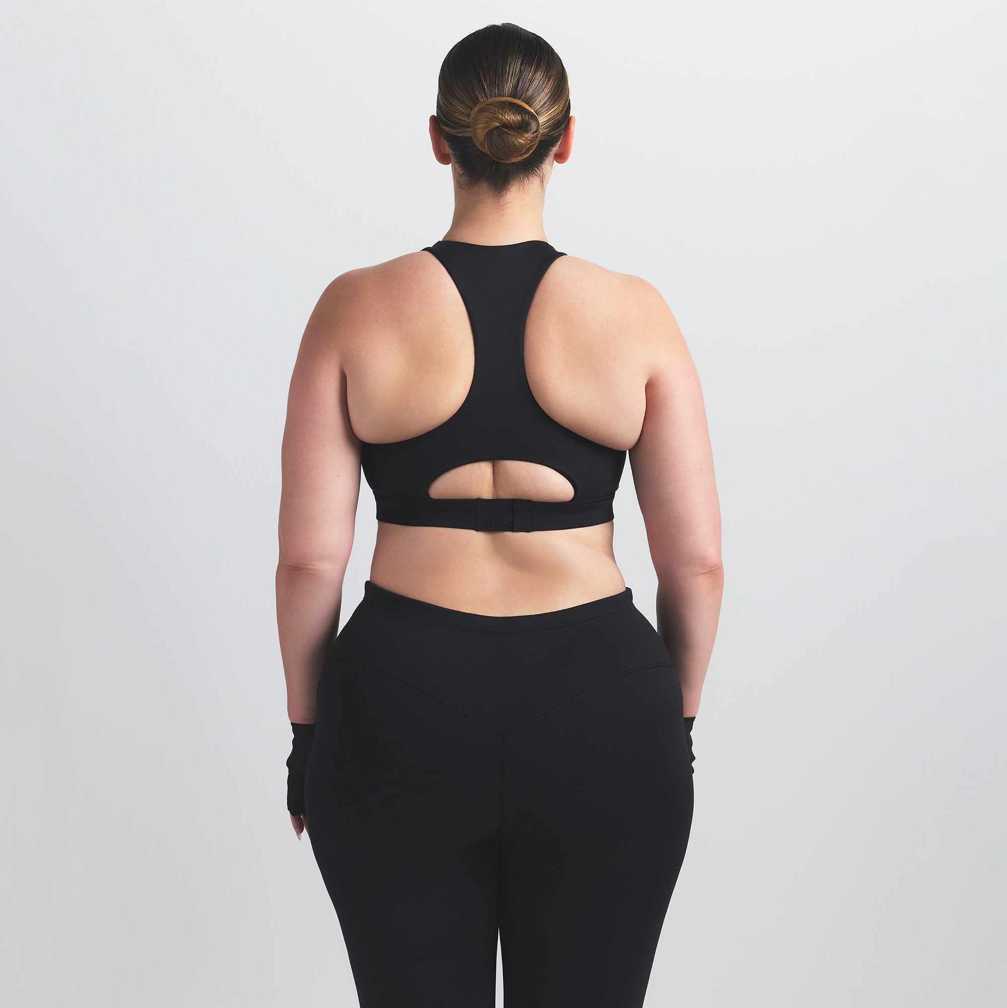 NikeSKIMS MATTE HIGH NECK BRA | OBSIDIAN ON A MODEL BACK VIEW @ | FOCUS: 0.0, 1.0, 0.9