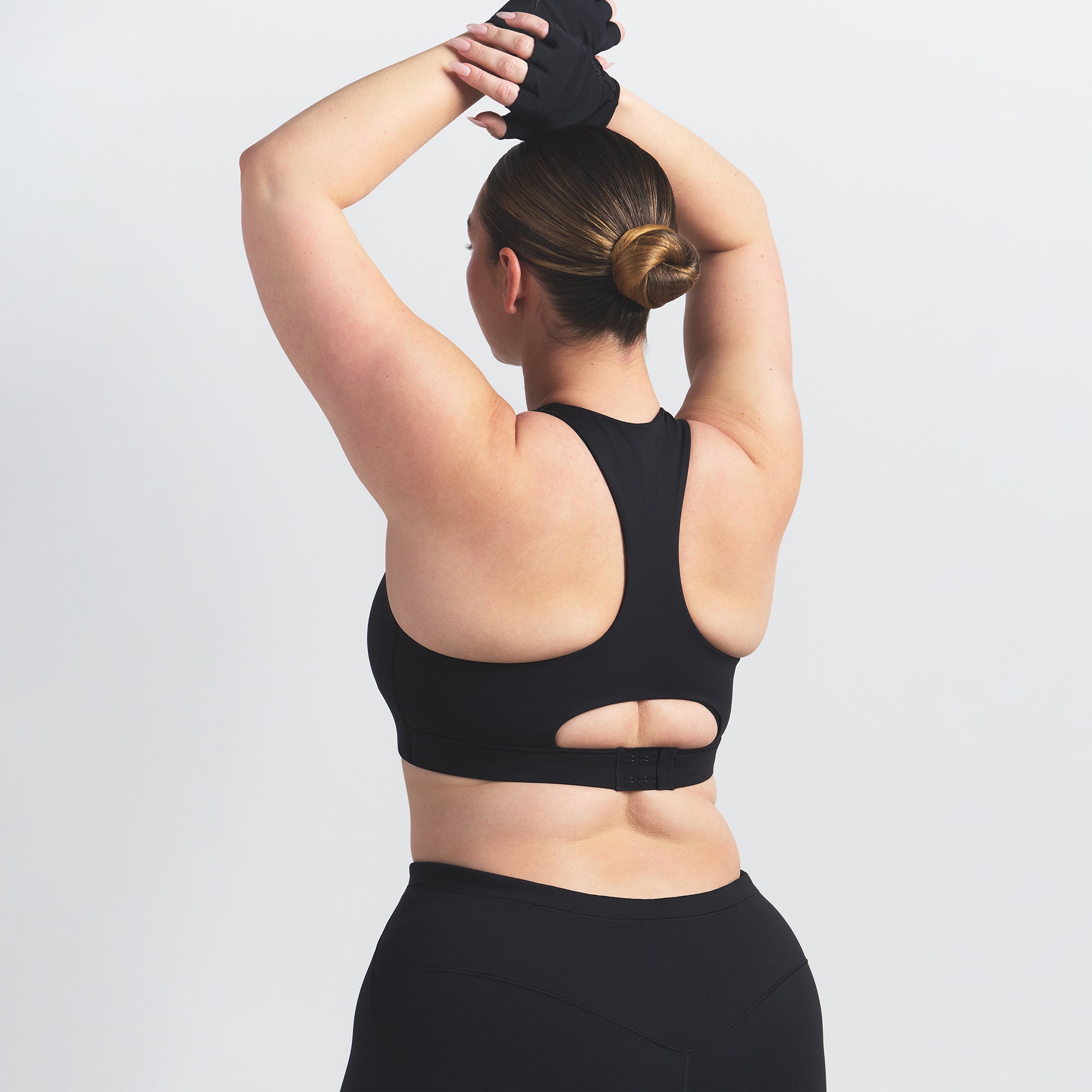 NikeSKIMS MATTE HIGH NECK BRA | OBSIDIAN ON A MODEL BACK VIEW @ | FOCUS: 0.0, 1.0, 0.9