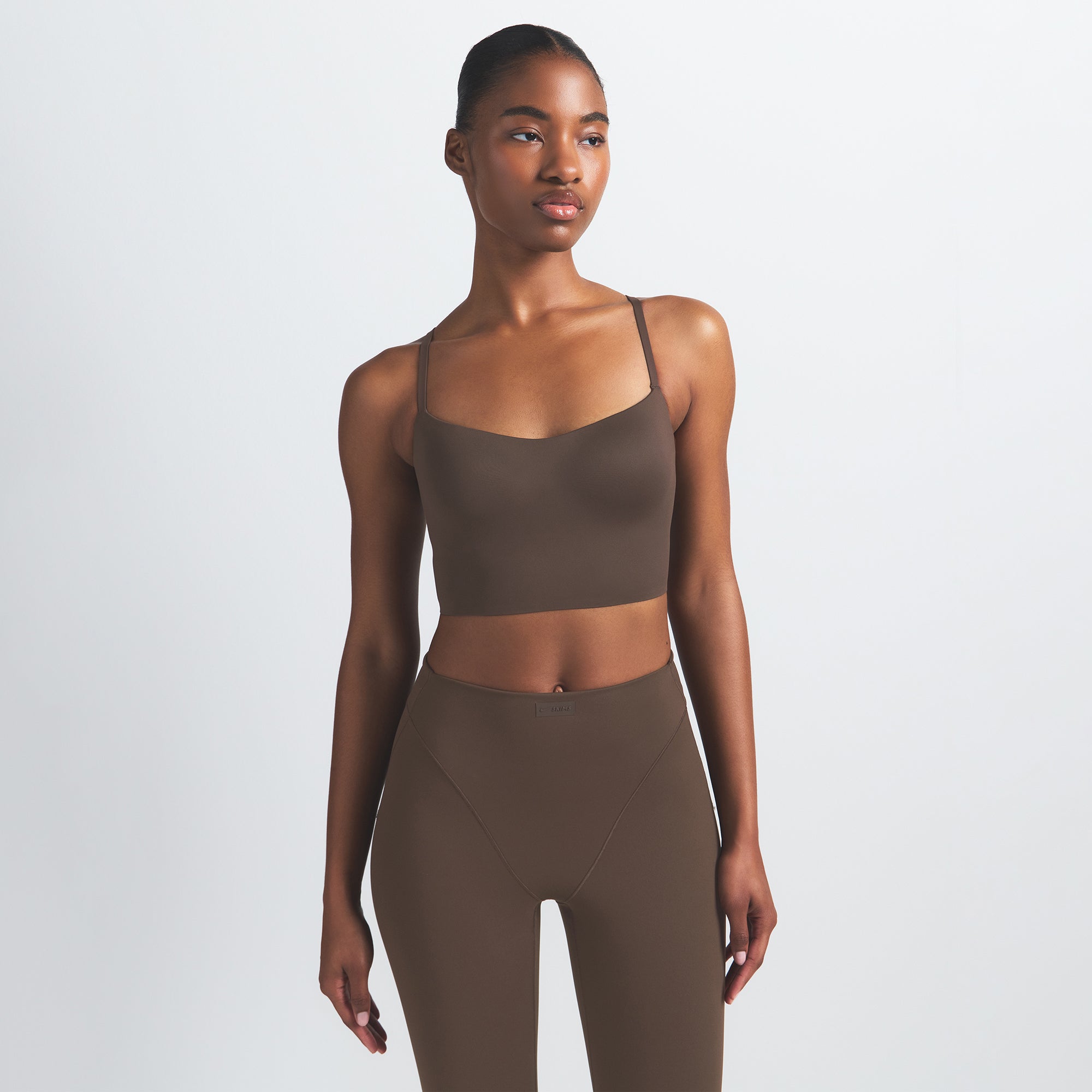 NikeSKIMS MATTE CAMI BRA TOP | DARK SEPIA ON A MODEL FRONT VIEW @ | FOCUS: 0.9, 0.1, 0.7