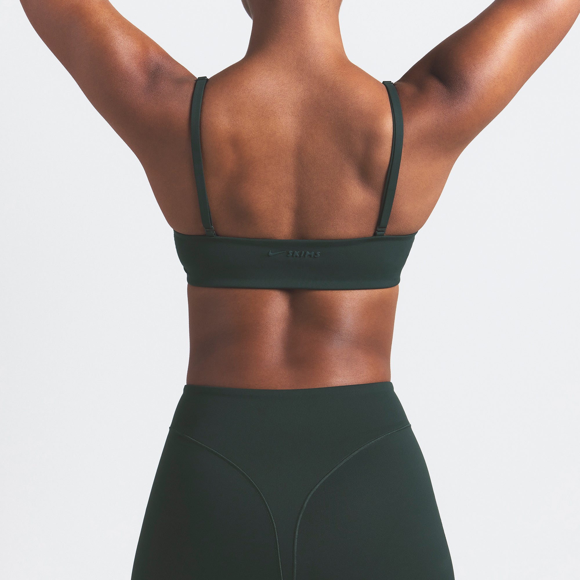 NikeSKIMS MATTE MICRO SCOOP BRA | DARK TEAL ON A MODEL SIDE VIEW @ | FOCUS: 0.0, 1.0, 0.9