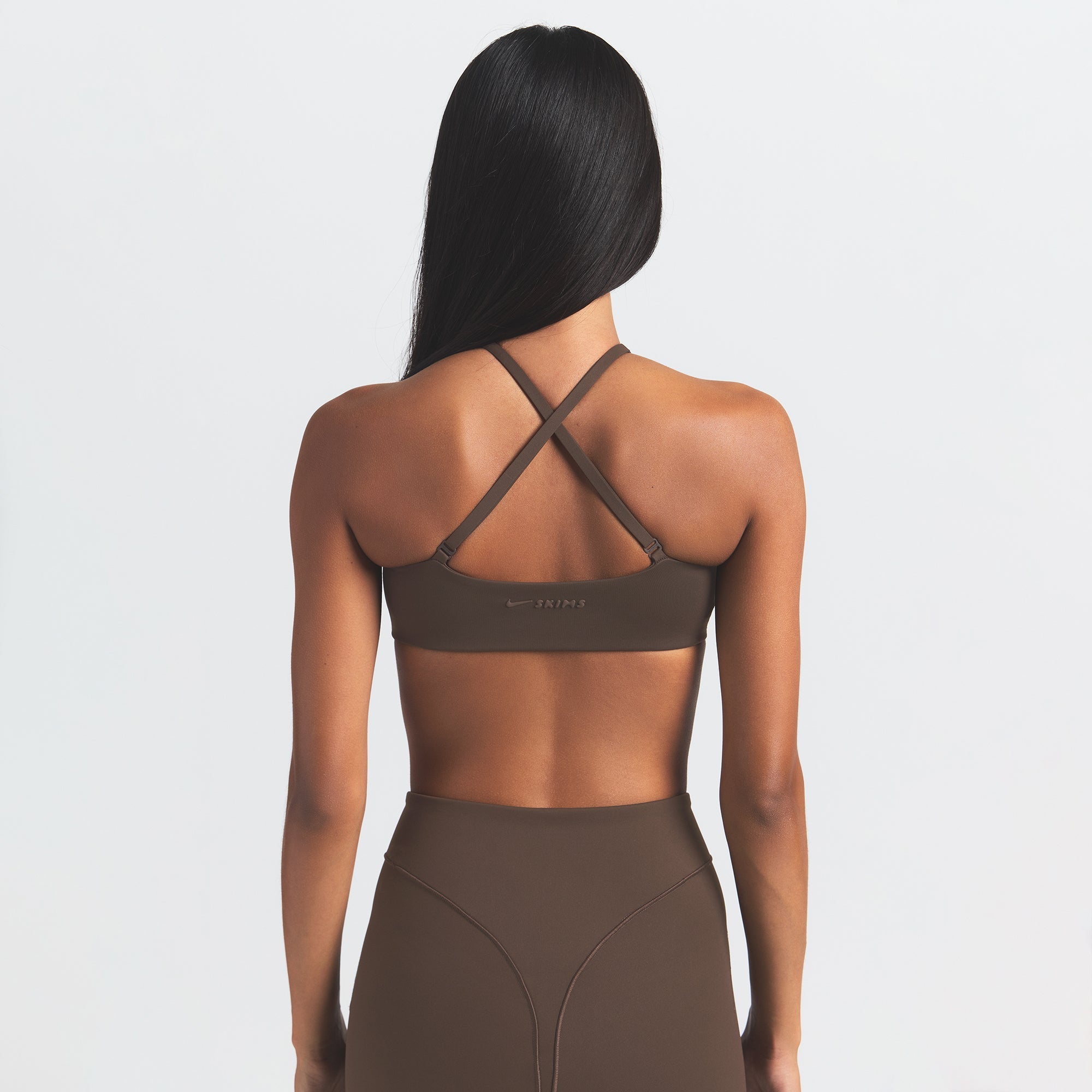 NikeSKIMS MATTE MICRO SCOOP BRA | DARK SEPIA ON A MODEL BACK VIEW