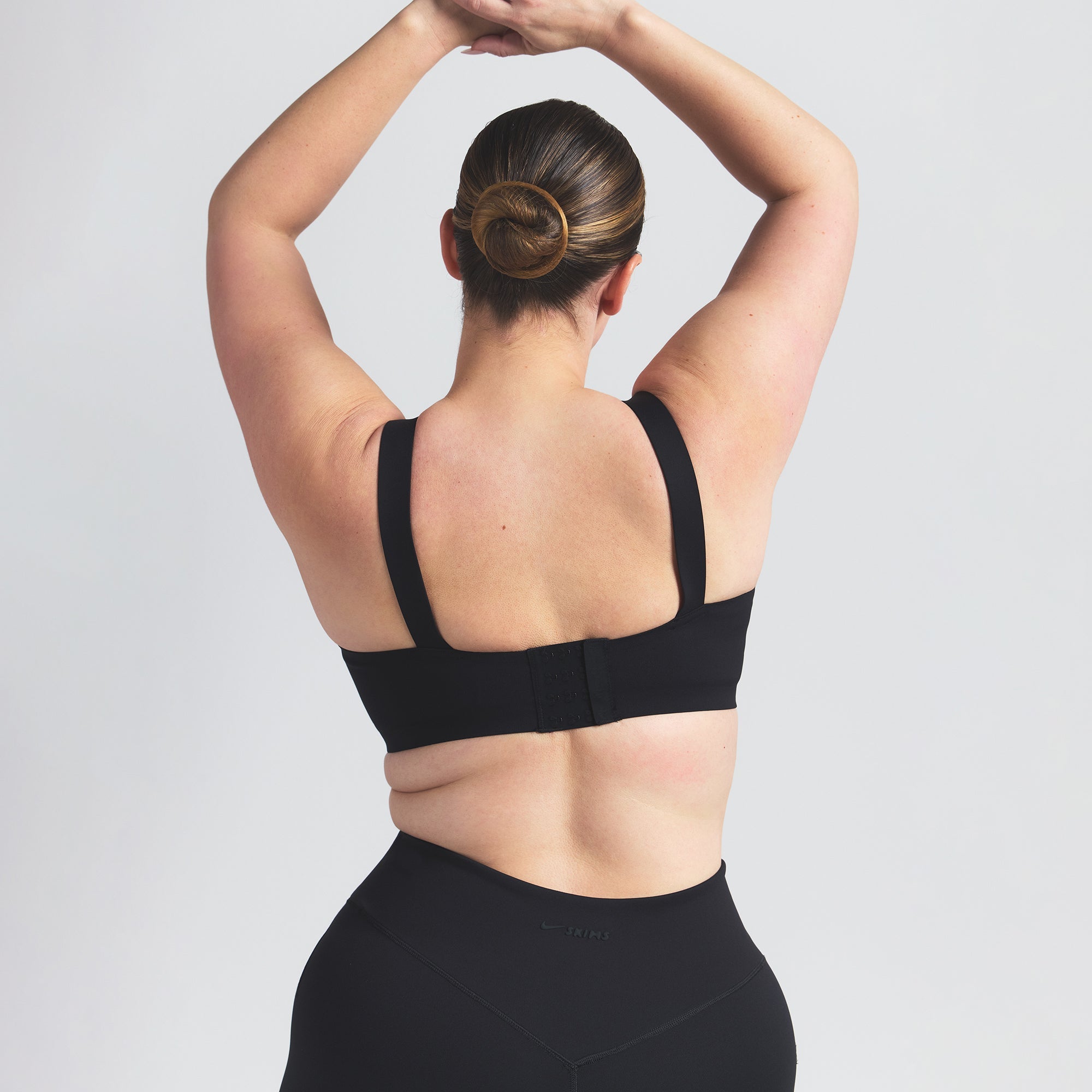 NikeSKIMS MATTE WIDE STRAP BRA | OBSIDIAN ON A MODEL BACK VIEW @ | FOCUS: 0.0, 1.0, 0.9