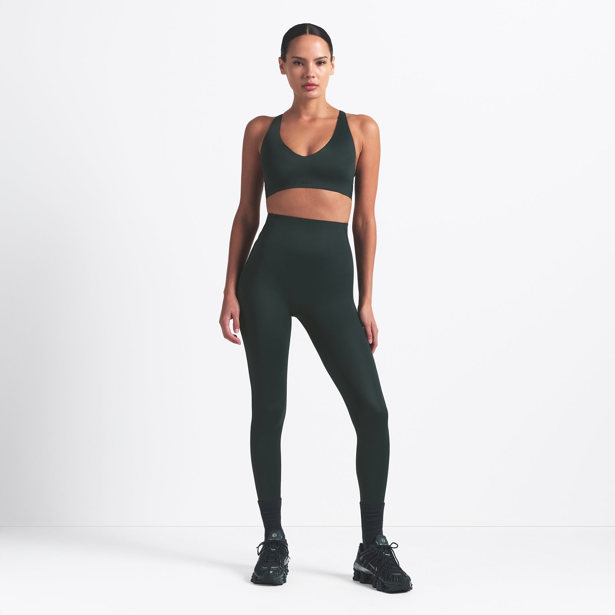 NikeSKIMS SHINE V-NECK BRA | DARK TEAL ON A MODEL FRONT VIEW @ | FOCUS: 0.0, 1.0, 0.9