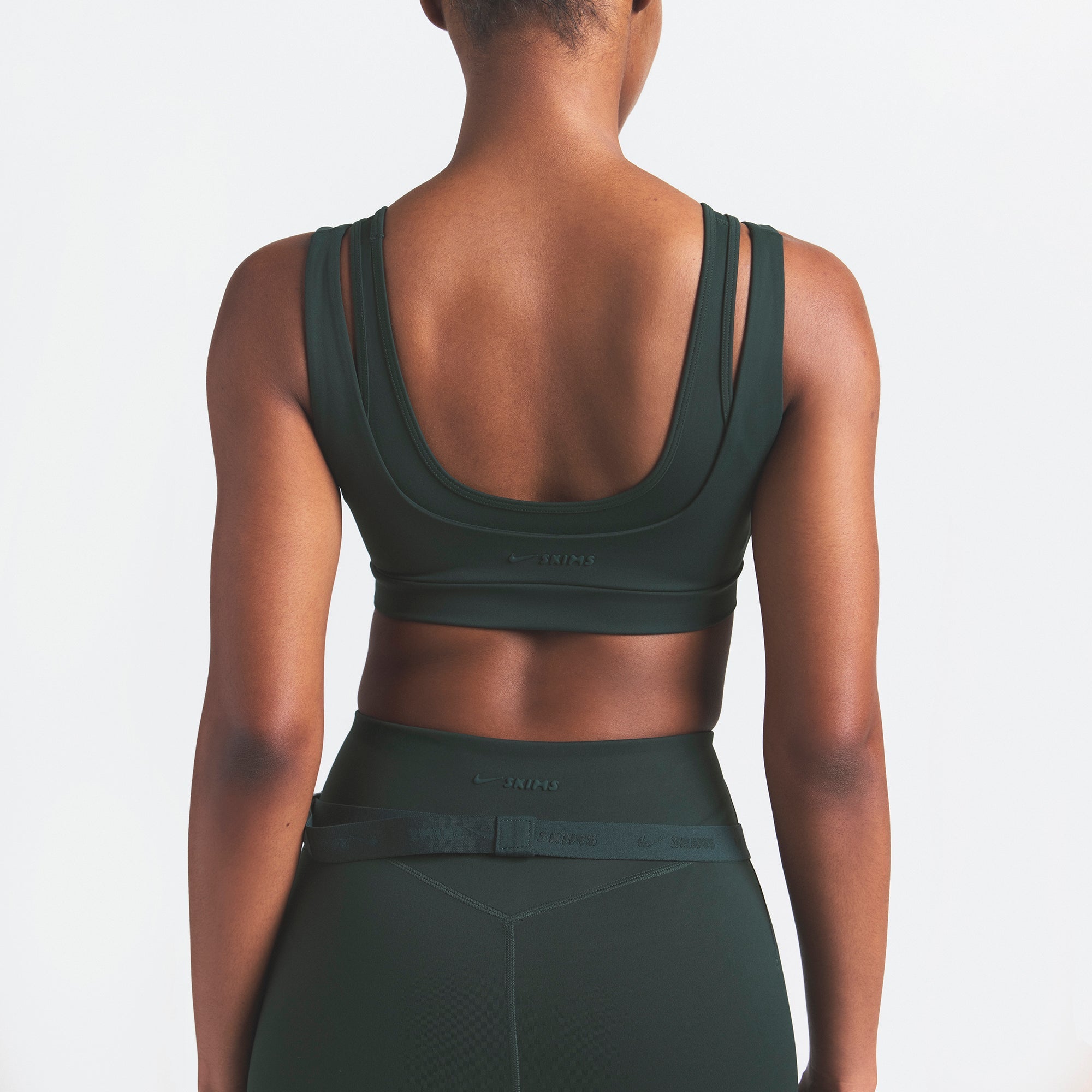 NikeSKIMS MATTE DOUBLE STRAP SCOOP BRA | DARK TEAL ON A MODEL SIDE VIEW @ | FOCUS: 0.0, 1.0, 0.9