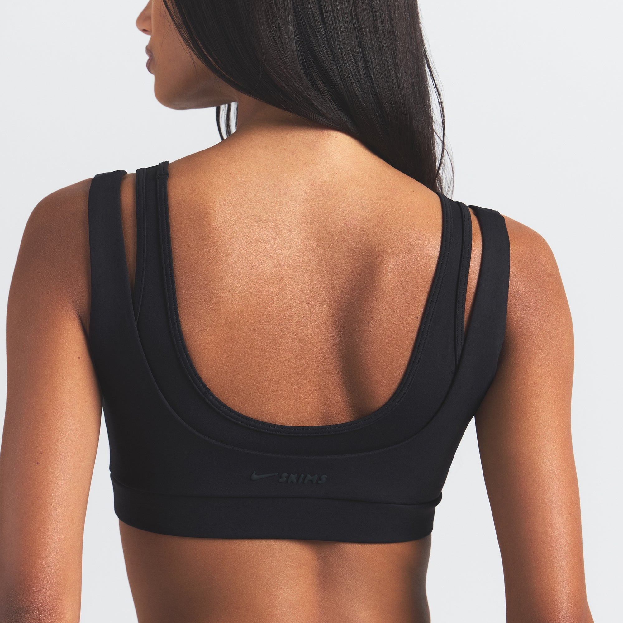 NikeSKIMS MATTE DOUBLE STRAP SCOOP BRA | OBSIDIAN ON A MODEL BACK VIEW @ | FOCUS: 0.0, 1.0, 0.9