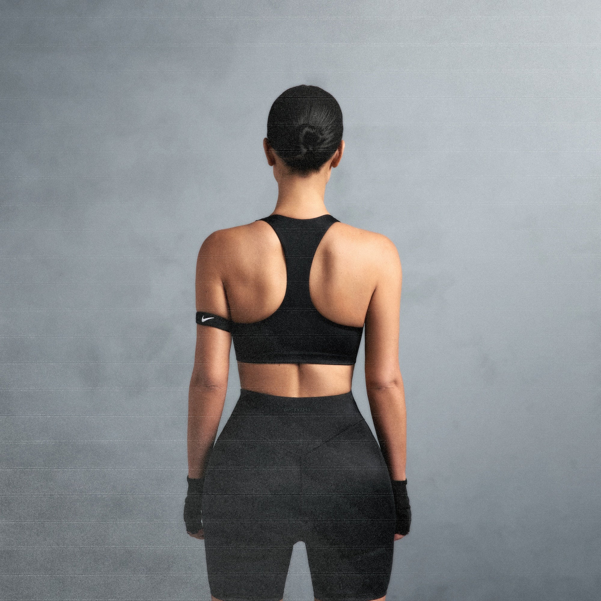 NikeSKIMS SHINE RACER BACK BRA | OBSIDIAN ON A MODEL SIDE VIEW @ | FOCUS: 0.0, 1.0, 0.9