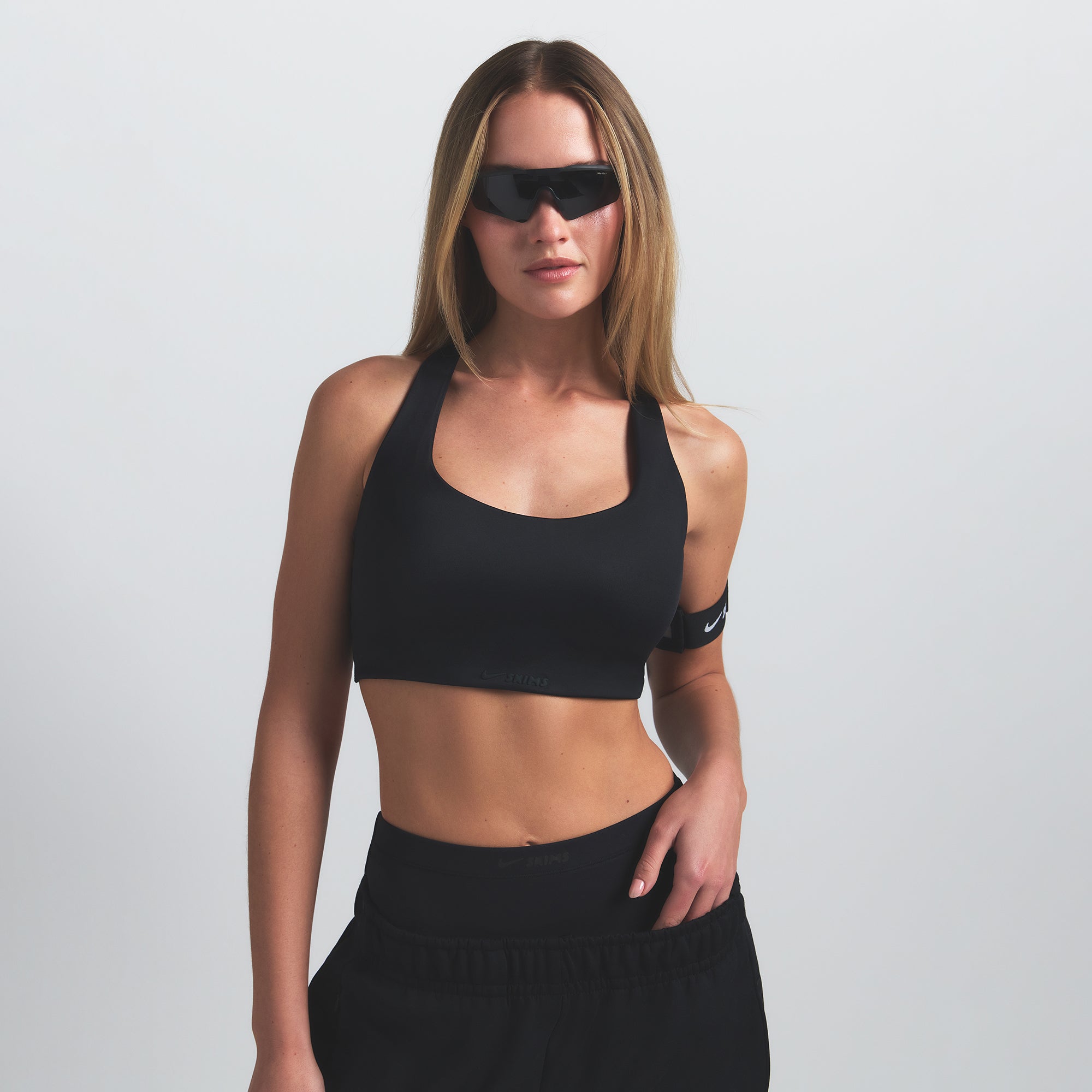 NikeSKIMS SHINE RACER BACK BRA | OBSIDIAN ON A MODEL SIDE VIEW @ | FOCUS: 0.9, 0.1, 0.7