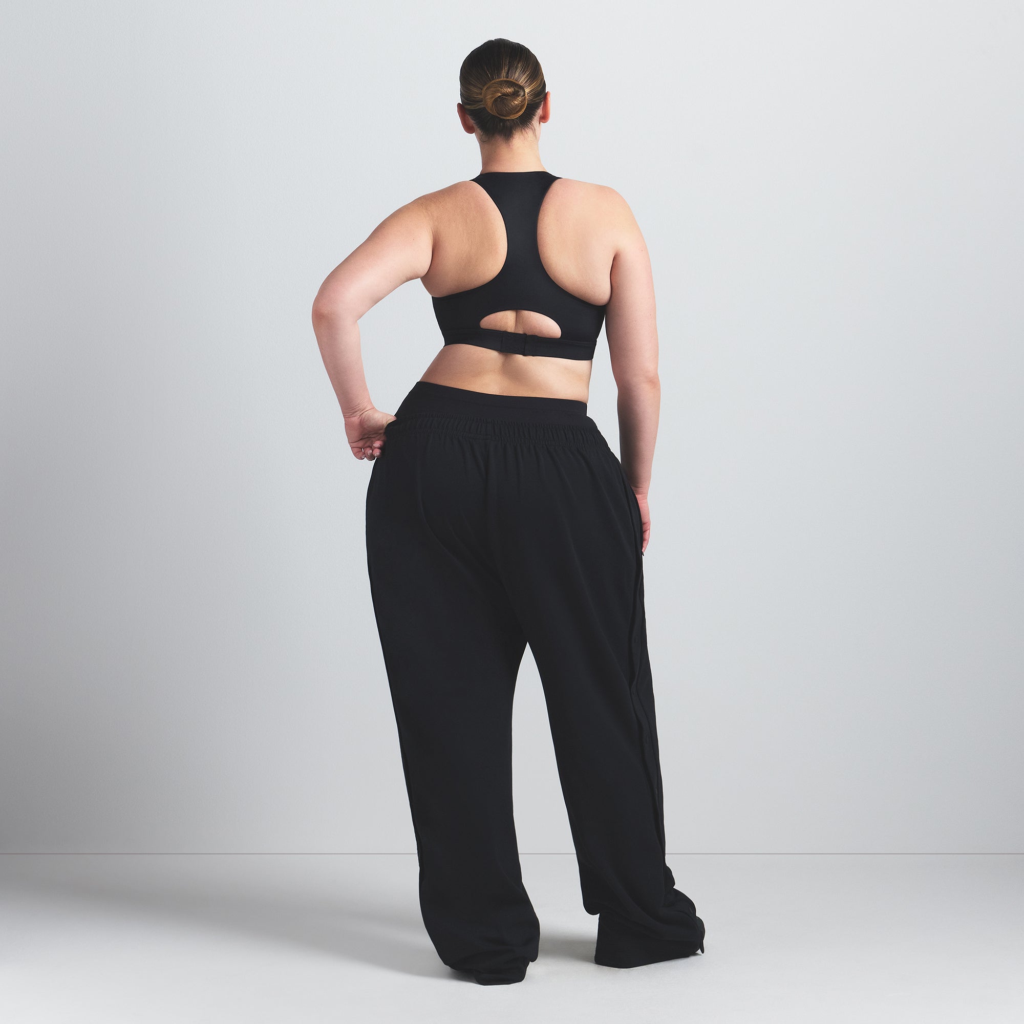 NikeSKIMS SHINE HIGH NECK BRA | OBSIDIAN ON A MODEL FRONT VIEW