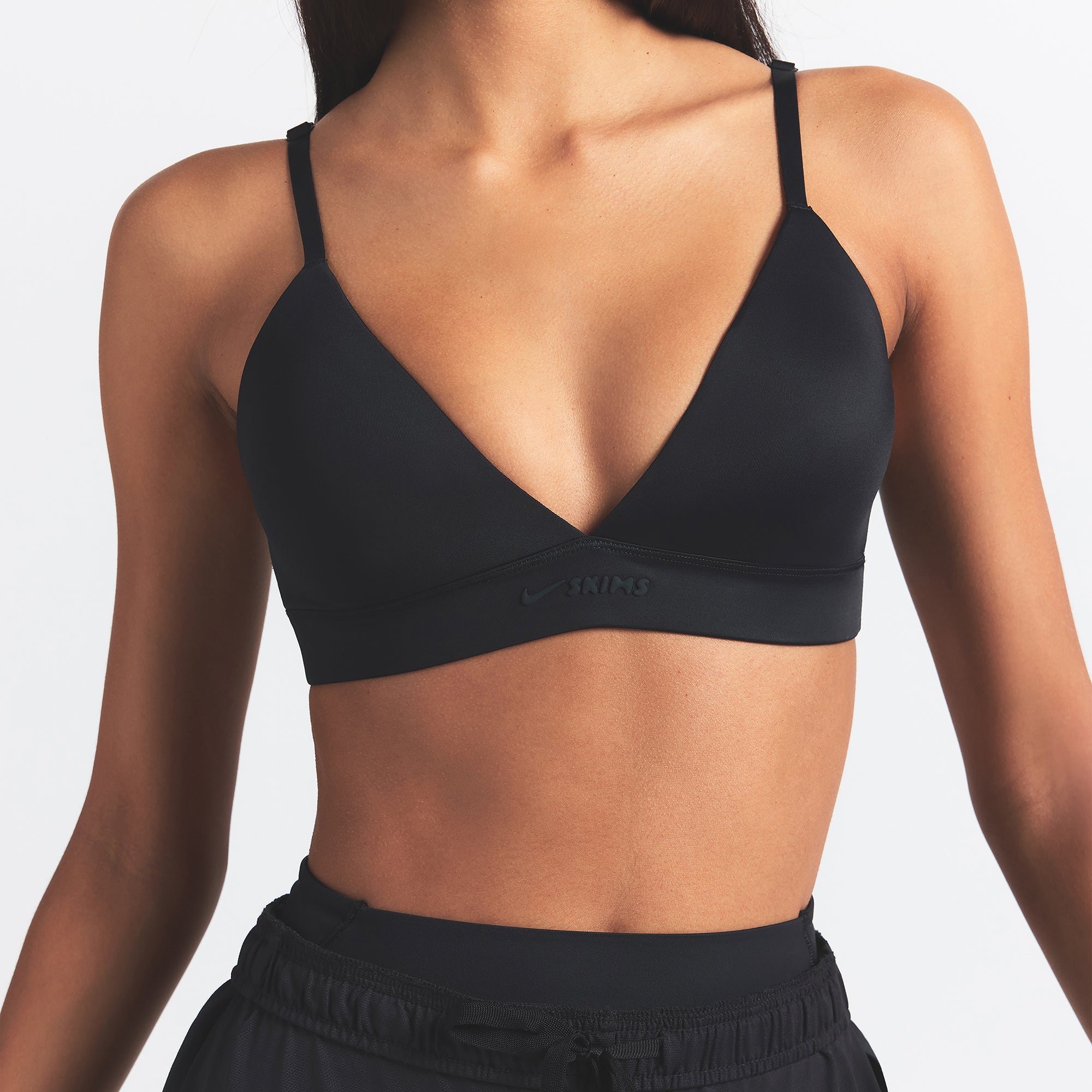 NikeSKIMS SHINE TRIANGLE BRA | OBSIDIAN ON A MODEL SIDE VIEW