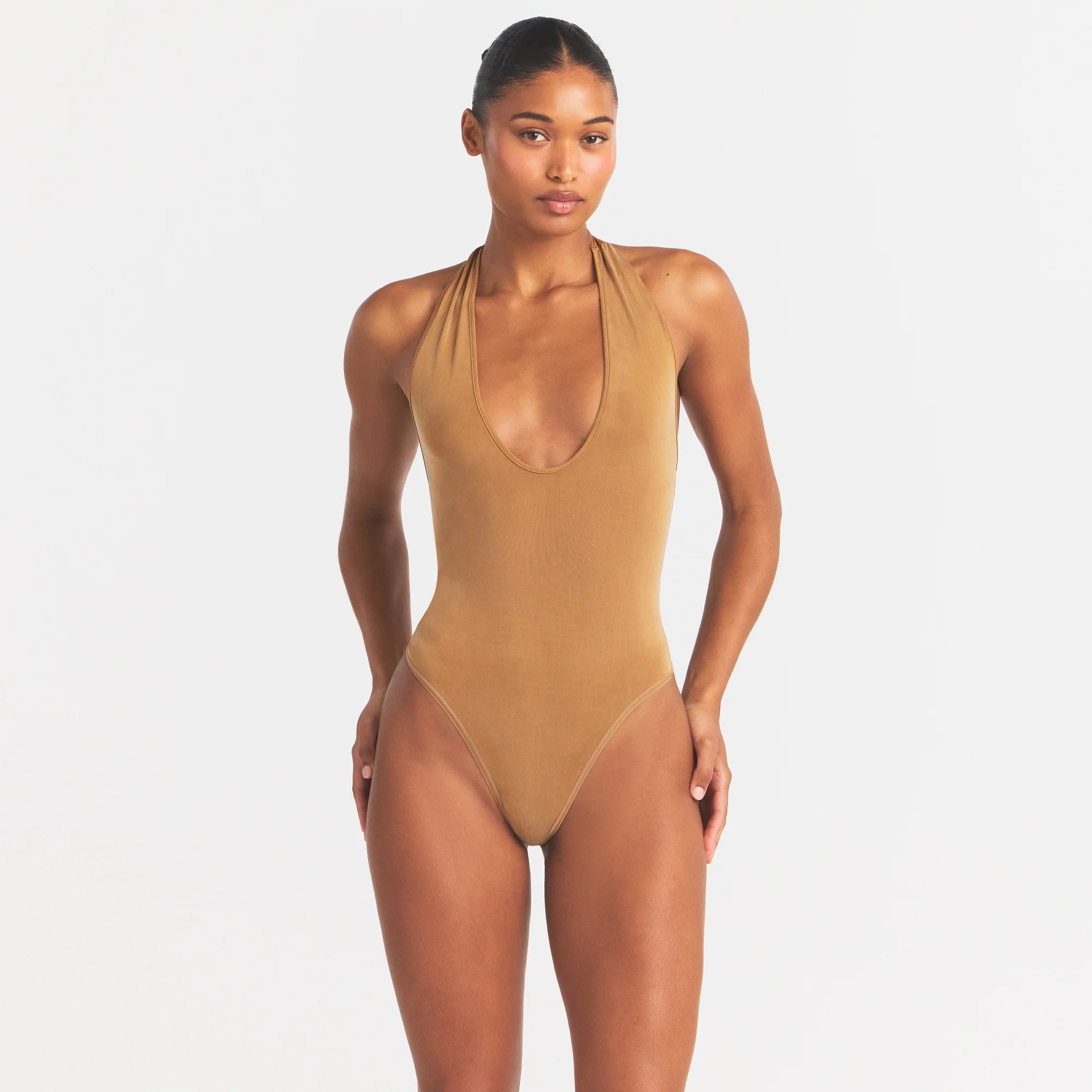 CUPRO JERSEY HALTER BODYSUIT | ALMOND ON A MODEL SIDE VIEW @ | FOCUS: 0.0, 1.0, 0.9