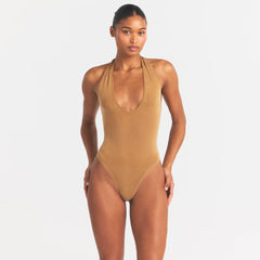 CUPRO JERSEY HALTER BODYSUIT | ALMOND ON A MODEL SIDE VIEW @ | FOCUS: 0.0, 1.0, 0.9