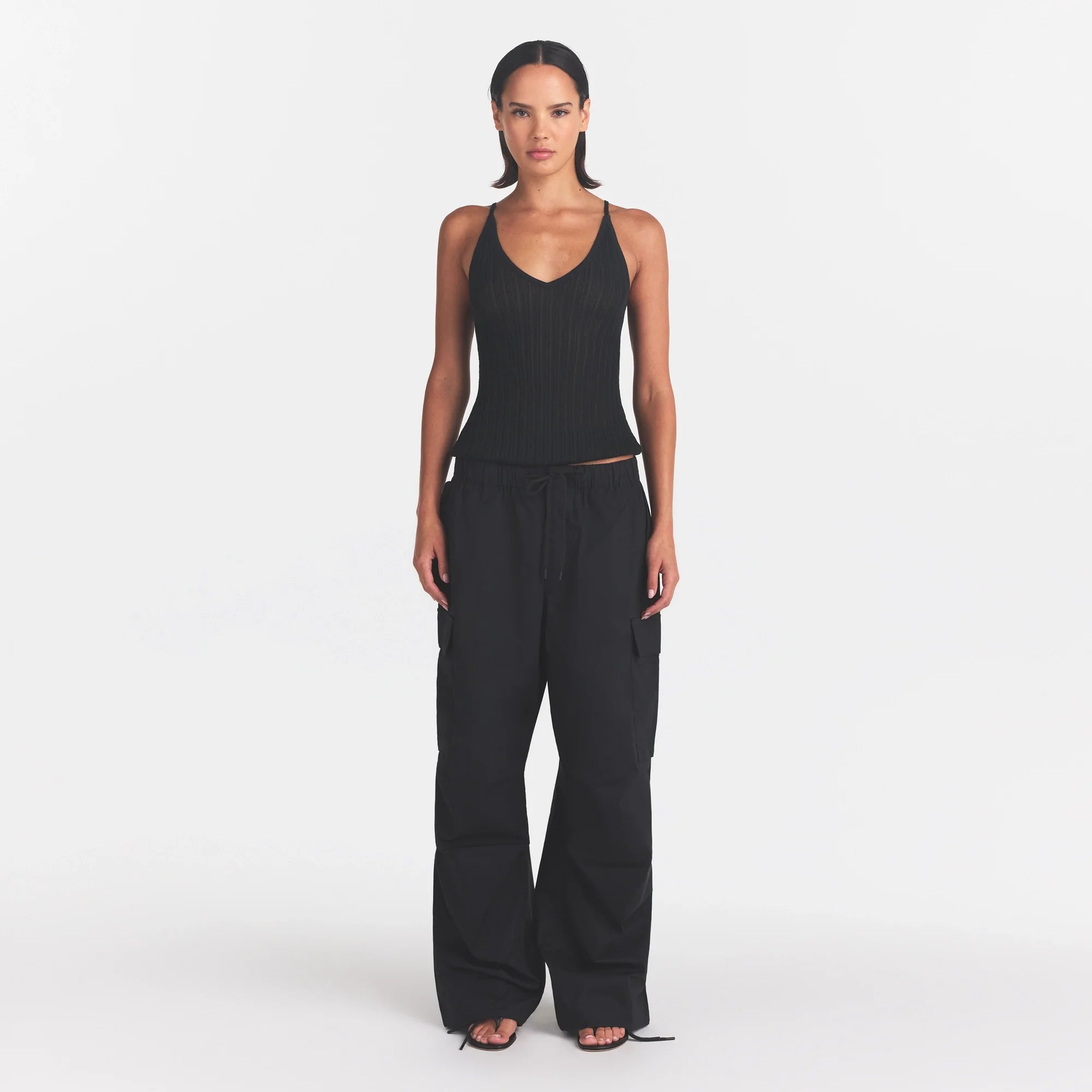 WOVEN COTTON OVERSIZED LOW RISE CARGO PANT | ONYX ON A MODEL FRONT VIEW @ | FOCUS: 0.0, 1.0, 0.9
