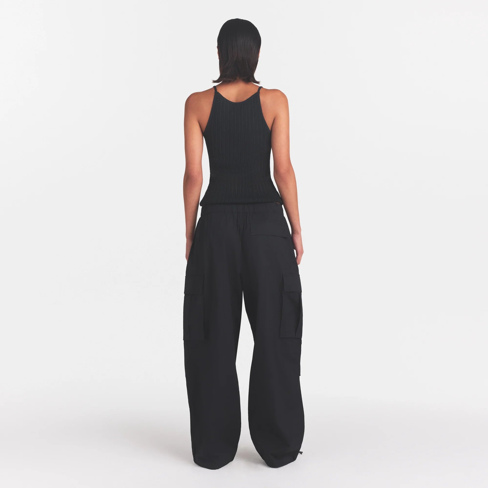 WOVEN COTTON OVERSIZED LOW RISE CARGO PANT | ONYX ON A MODEL FRONT VIEW @ | FOCUS: 0.0, 1.0, 0.9