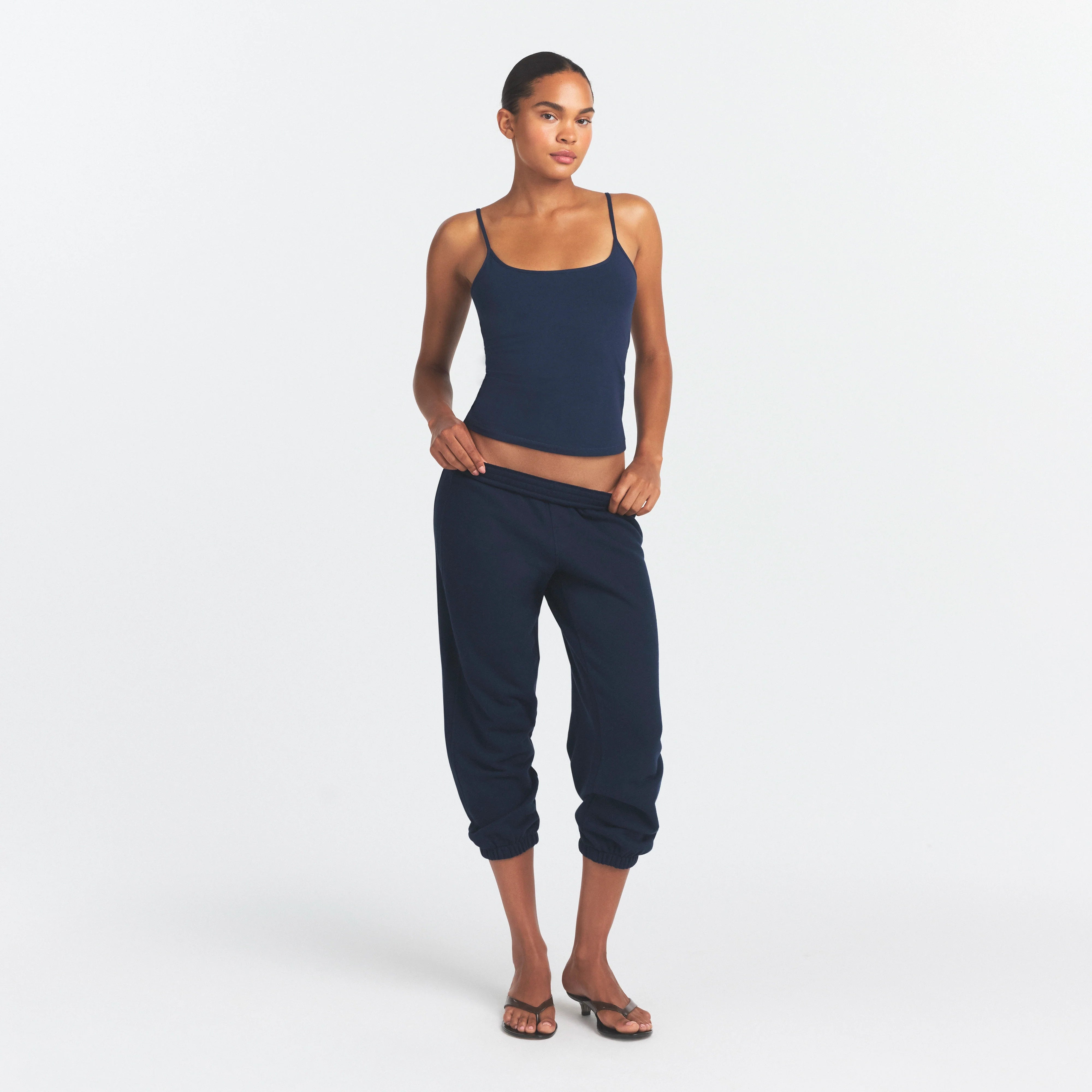 DRAPEY FRENCH TERRY CROPPED JOGGER | NAVY ON A MODEL FRONT VIEW @ | FOCUS: 0.0, 1.0, 0.9