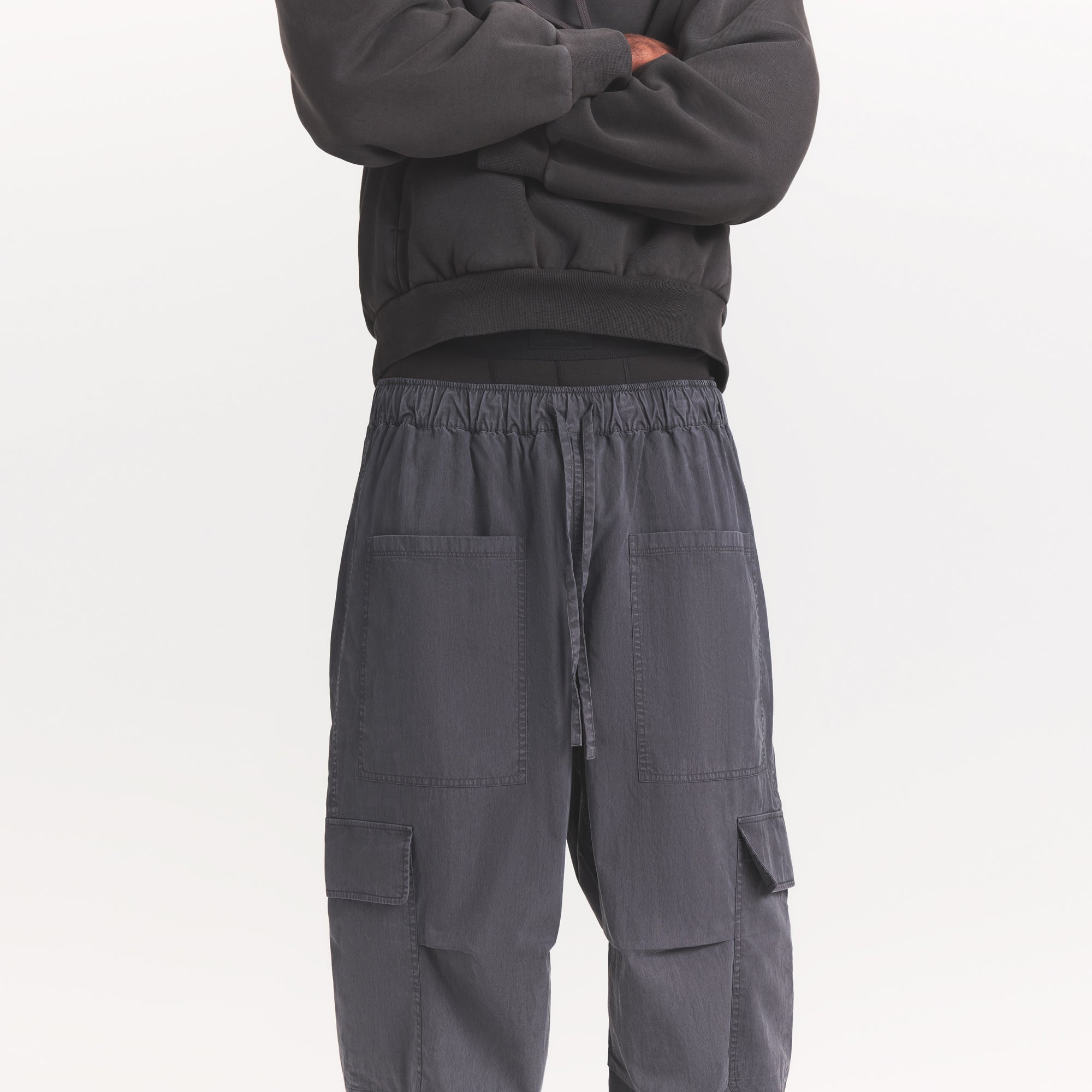WOVEN MENS CARGO PANT | ASH ON A MODEL SIDE VIEW @ | FOCUS: 0.0, 1.0, 0.9