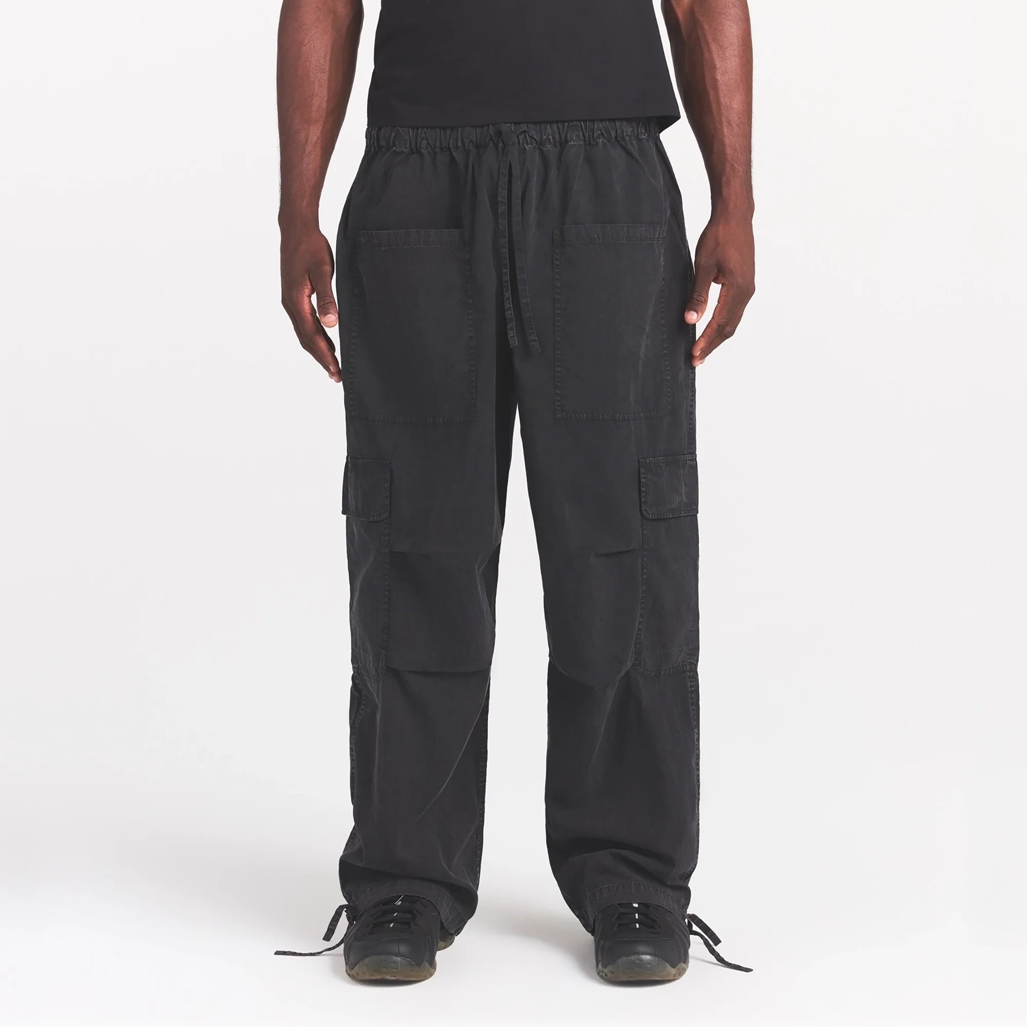 WOVEN MENS CARGO PANT | ONYX ON A MODEL SIDE VIEW @ | FOCUS: 0.0, 1.0, 0.9