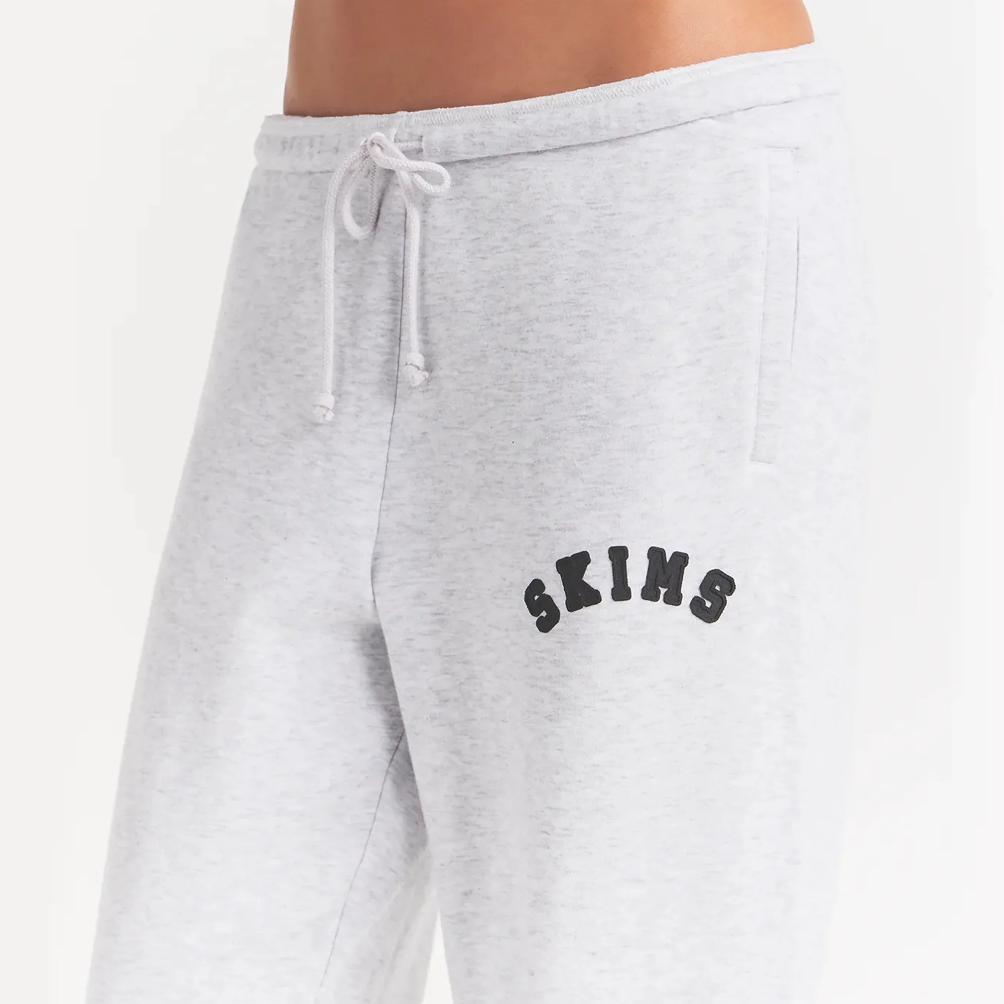 COTTON FLEECE JOGGER | LIGHT HEATHER GREY WITH ONYX LOGO ON A MODEL SIDE VIEW @ | FOCUS: 0.0, 1.0, 0.9