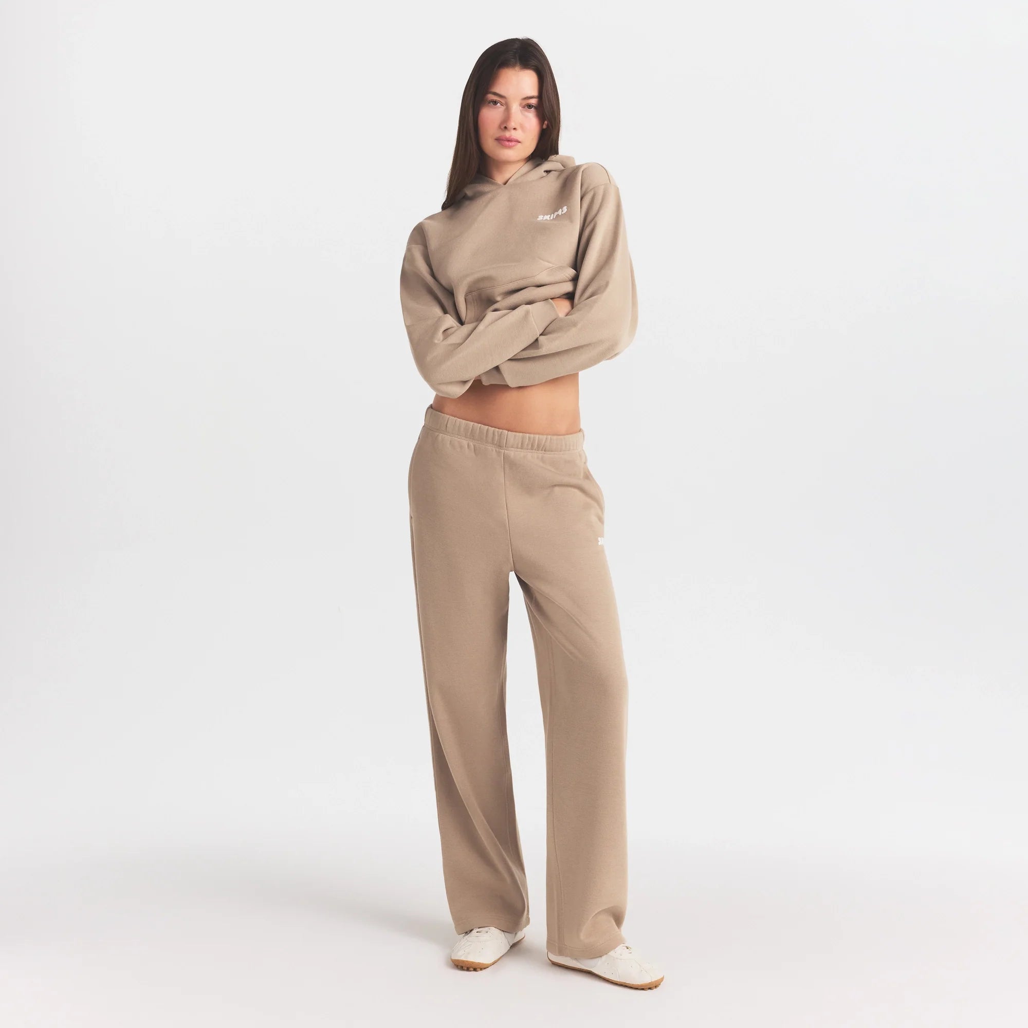COTTON FLEECE STRAIGHT LEG PANT WITH EMBOSSED LOGO | LATTE ON A MODEL FRONT VIEW @ | FOCUS: 0.0, 1.0, 0.9