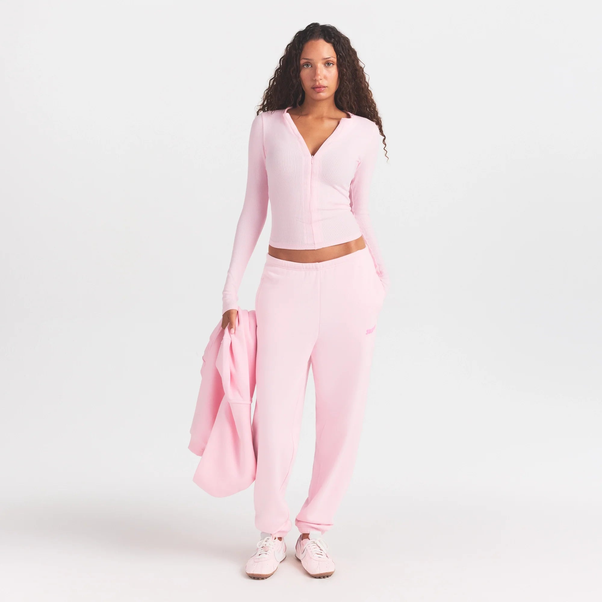 COTTON FLEECE JOGGER WITH EMBOSSED LOGO | CHERRY BLOSSOM ON A MODEL FRONT VIEW @ | FOCUS: 0.0, 1.0, 0.9