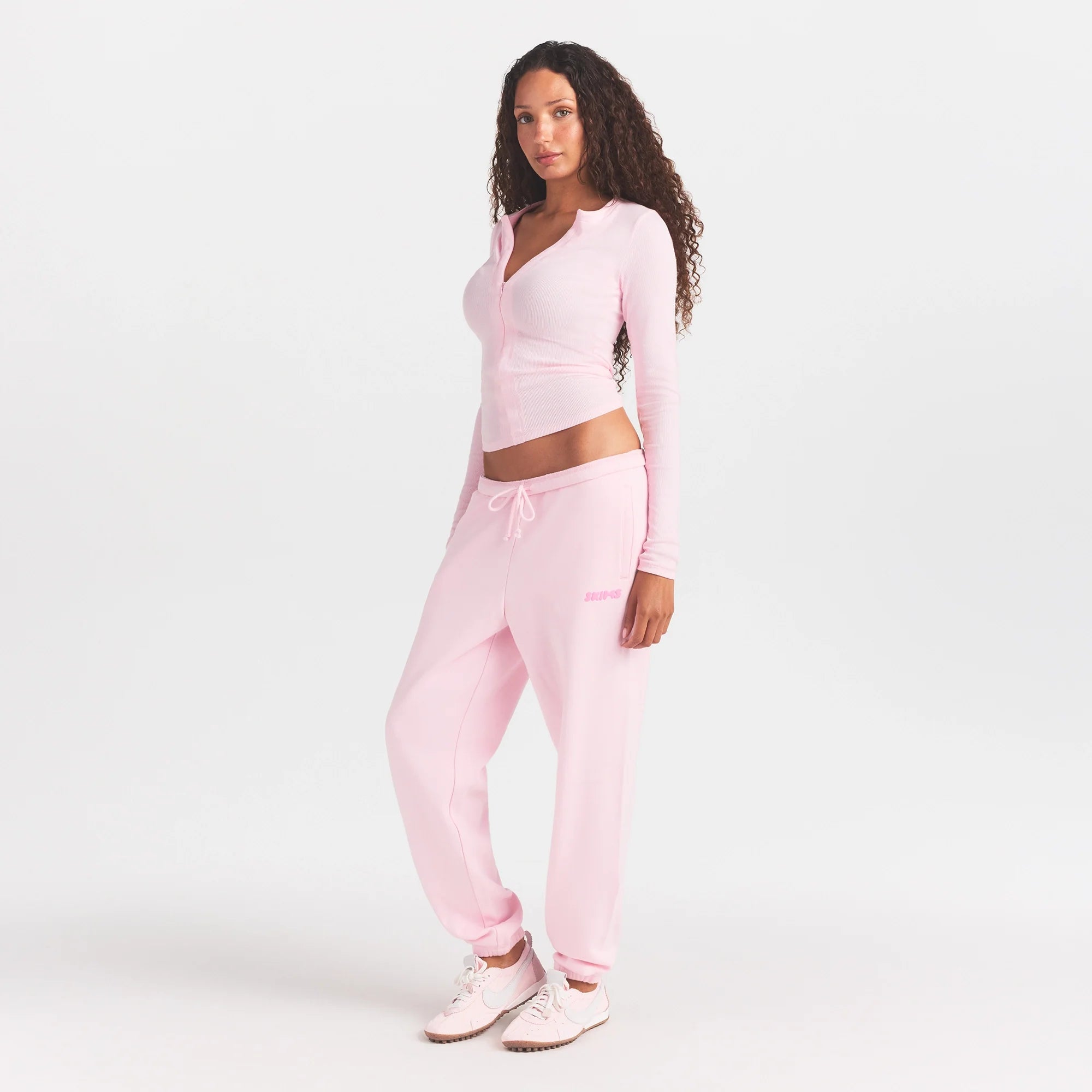 COTTON FLEECE JOGGER WITH EMBOSSED LOGO | CHERRY BLOSSOM ON A MODEL FRONT VIEW @ | FOCUS: 0.0, 1.0, 0.9