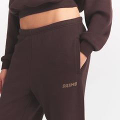 COTTON FLEECE JOGGER WITH EMBOSSED LOGO | ESPRESSO ON A MODEL SIDE VIEW @ | FOCUS: 0.0, 1.0, 0.9