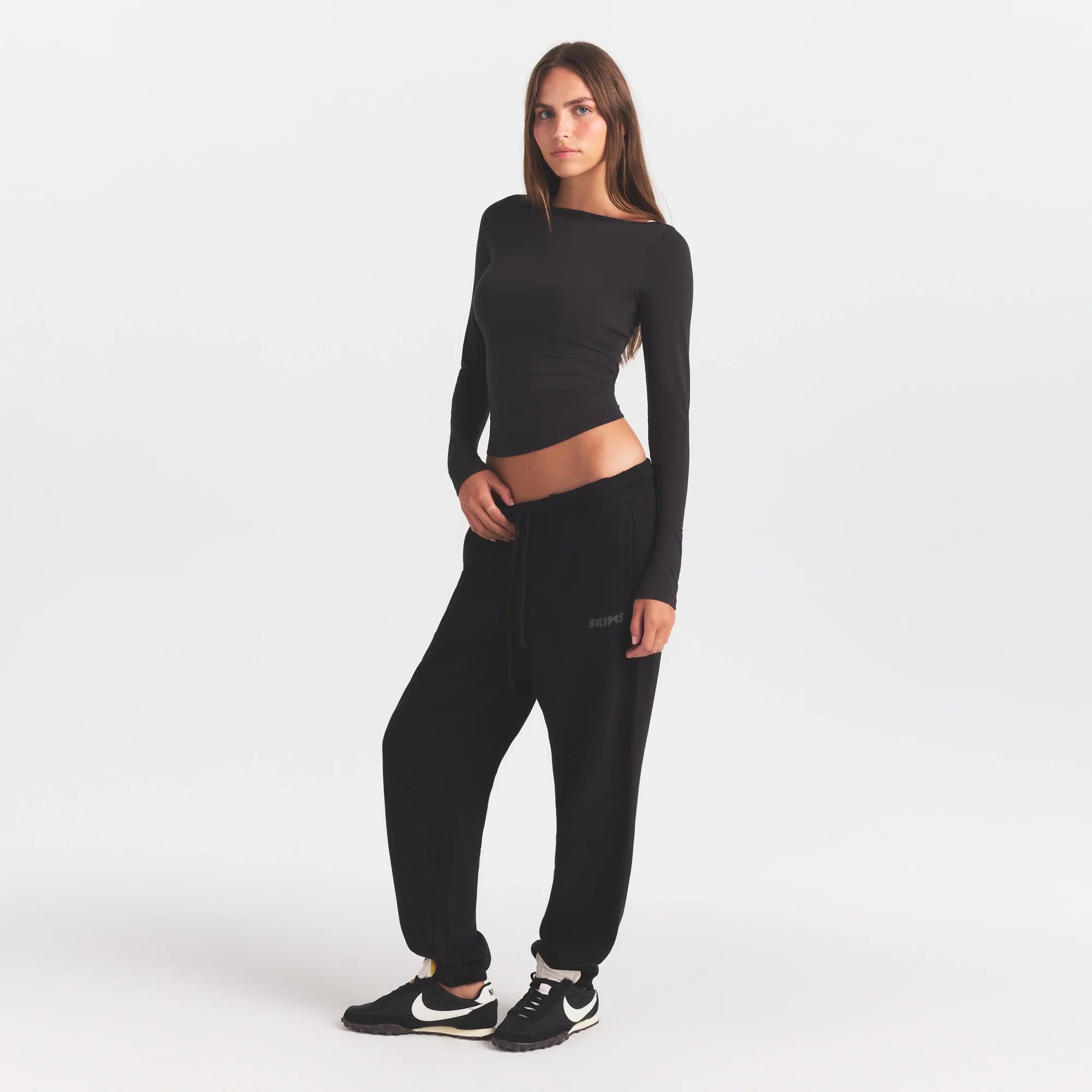 COTTON FLEECE JOGGER WITH EMBOSSED LOGO | ONYX & LAYS FLAT ON A WHITE BACKGROUND | FLT @ | FOCUS: 0.0, 1.0, 0.9