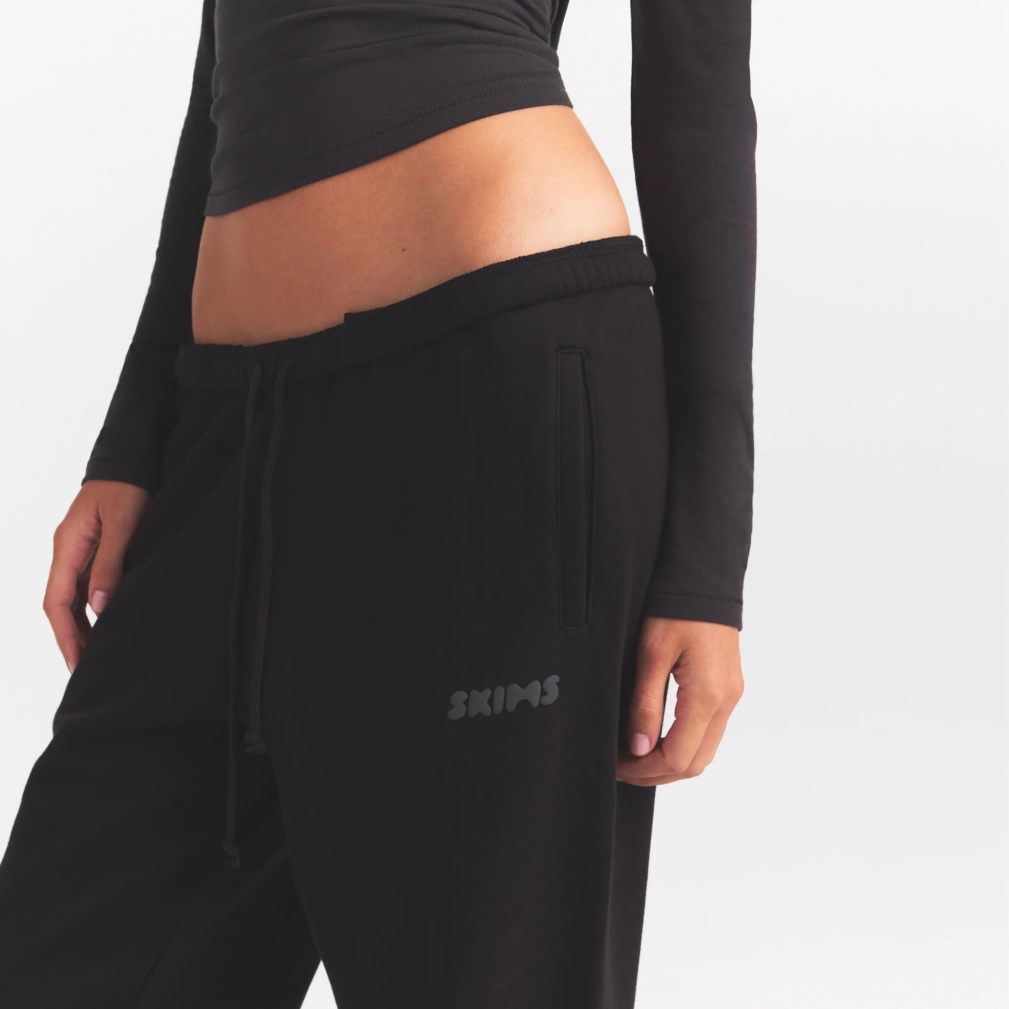 COTTON FLEECE JOGGER WITH EMBOSSED LOGO | ONYX & LAYS FLAT ON A WHITE BACKGROUND | FLT @ | FOCUS: 0.0, 1.0, 0.9
