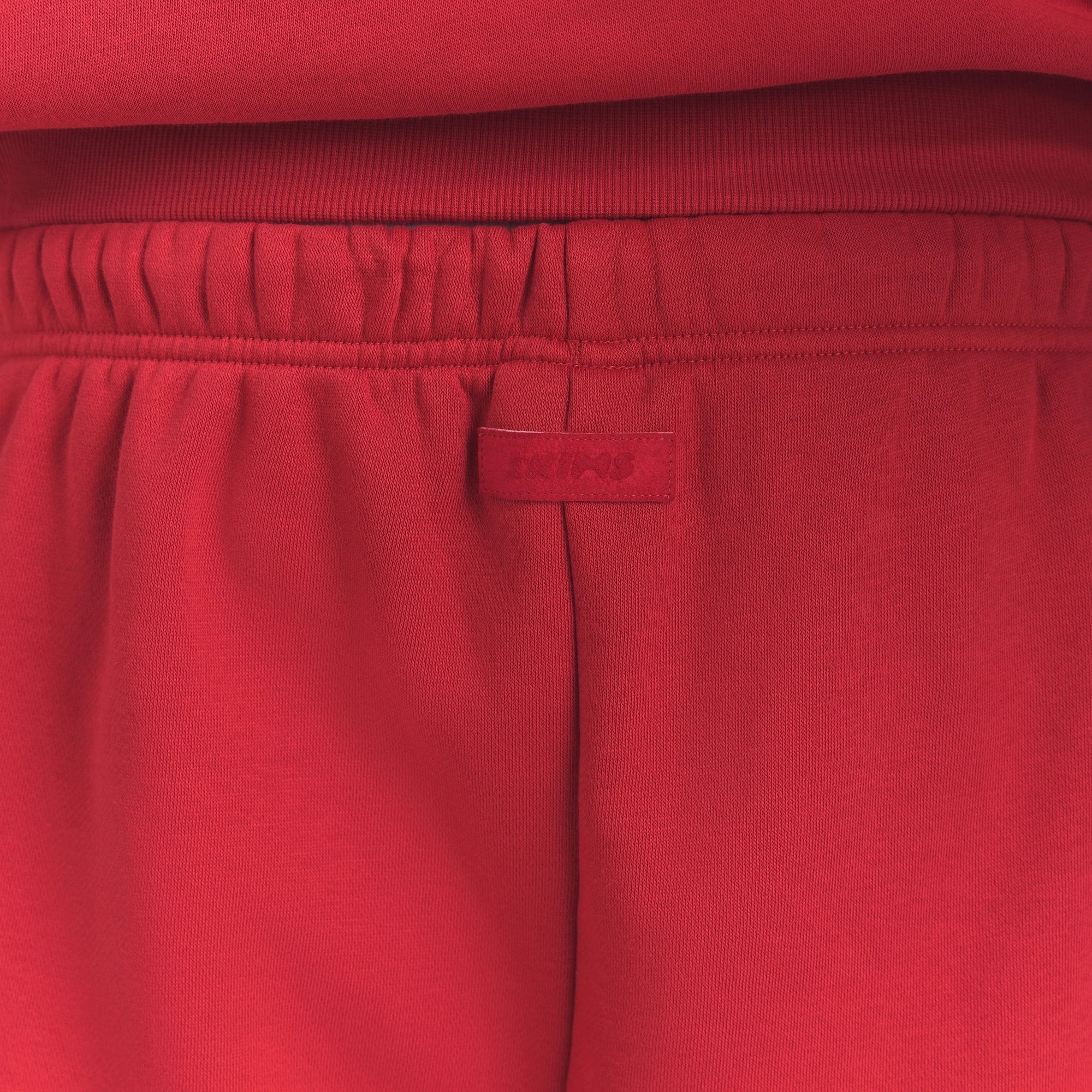 FLEECE LOUNGE MENS RELAXED LONG SHORT | WASHED RED ON A MODEL SIDE VIEW @ | FOCUS: 0.0, 1.0, 0.9