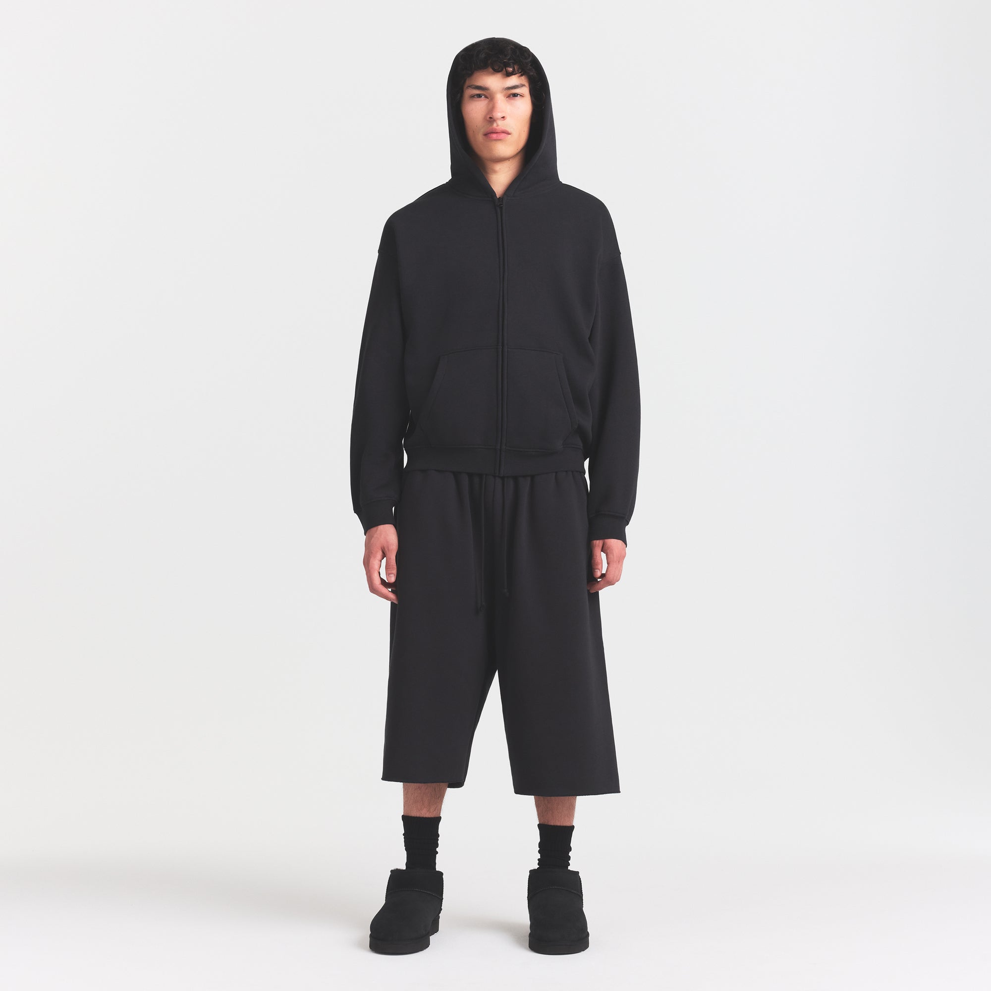 FLEECE LOUNGE MENS RELAXED LONG SHORT | WASHED ONYX ON A MODEL FRONT VIEW @ | FOCUS: 0.0, 1.0, 0.9