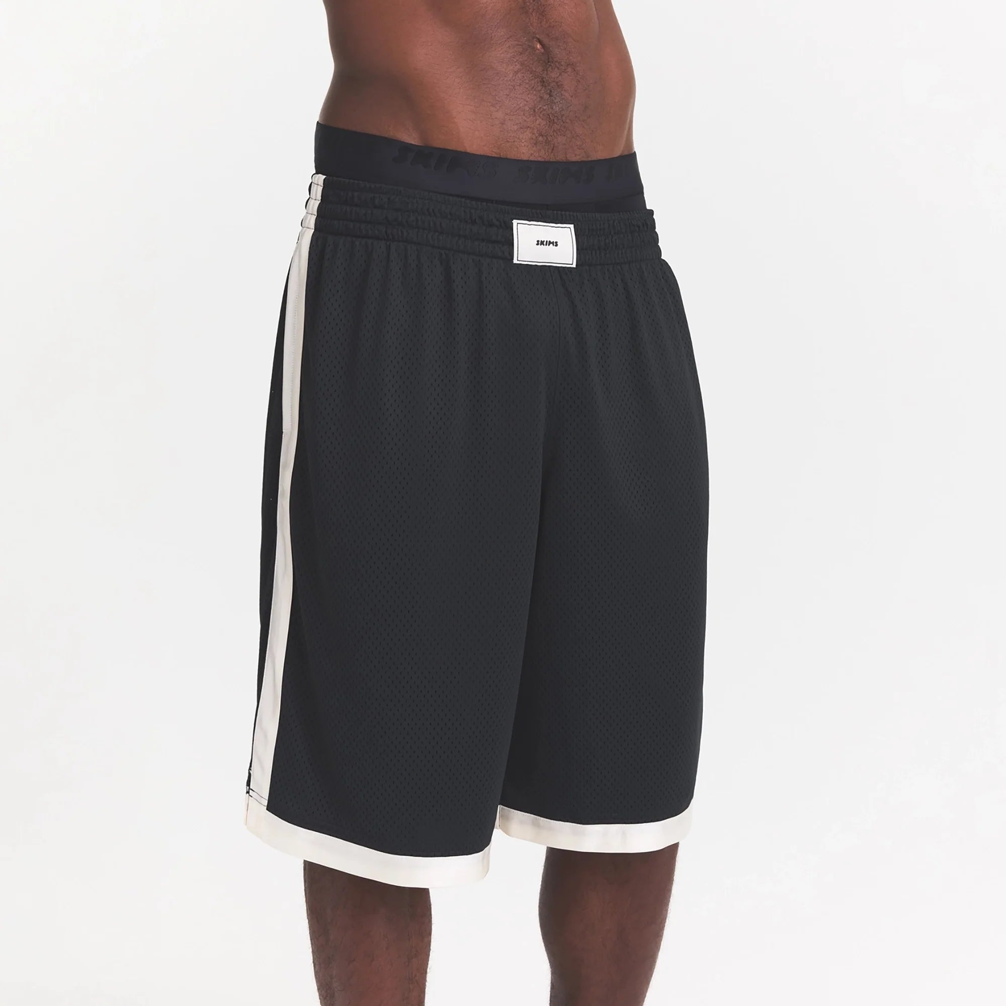 MESH APPAREL MENS LONG SHORT | ONYX ON A MODEL SIDE VIEW @ | FOCUS: 0.0, 1.0, 0.9