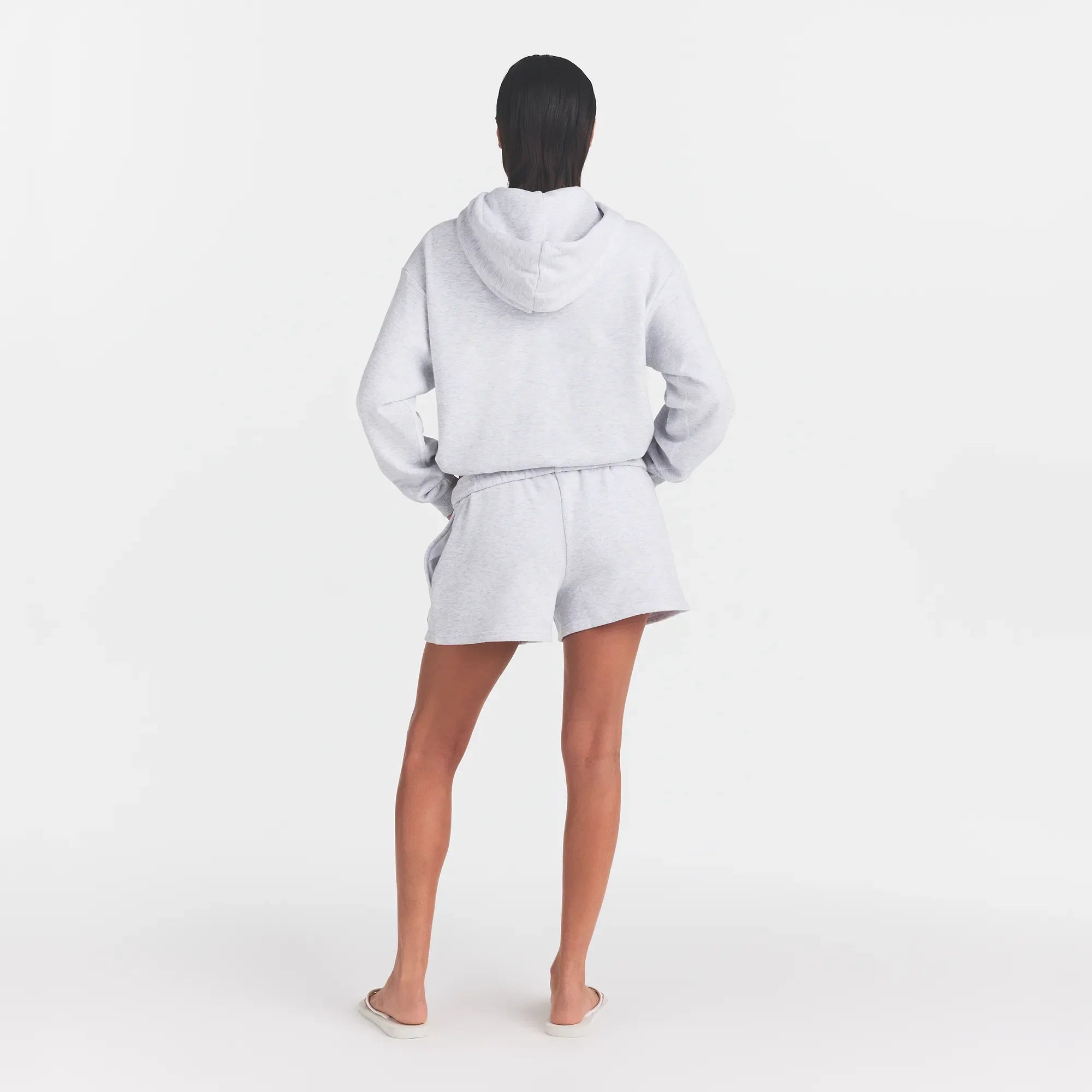 COTTON FLEECE CLASSIC SHORT | LIGHT HEATHER GREY WITH ONYX LOGO ON A MODEL BACK VIEW @ | FOCUS: 0.0, 1.0, 0.9