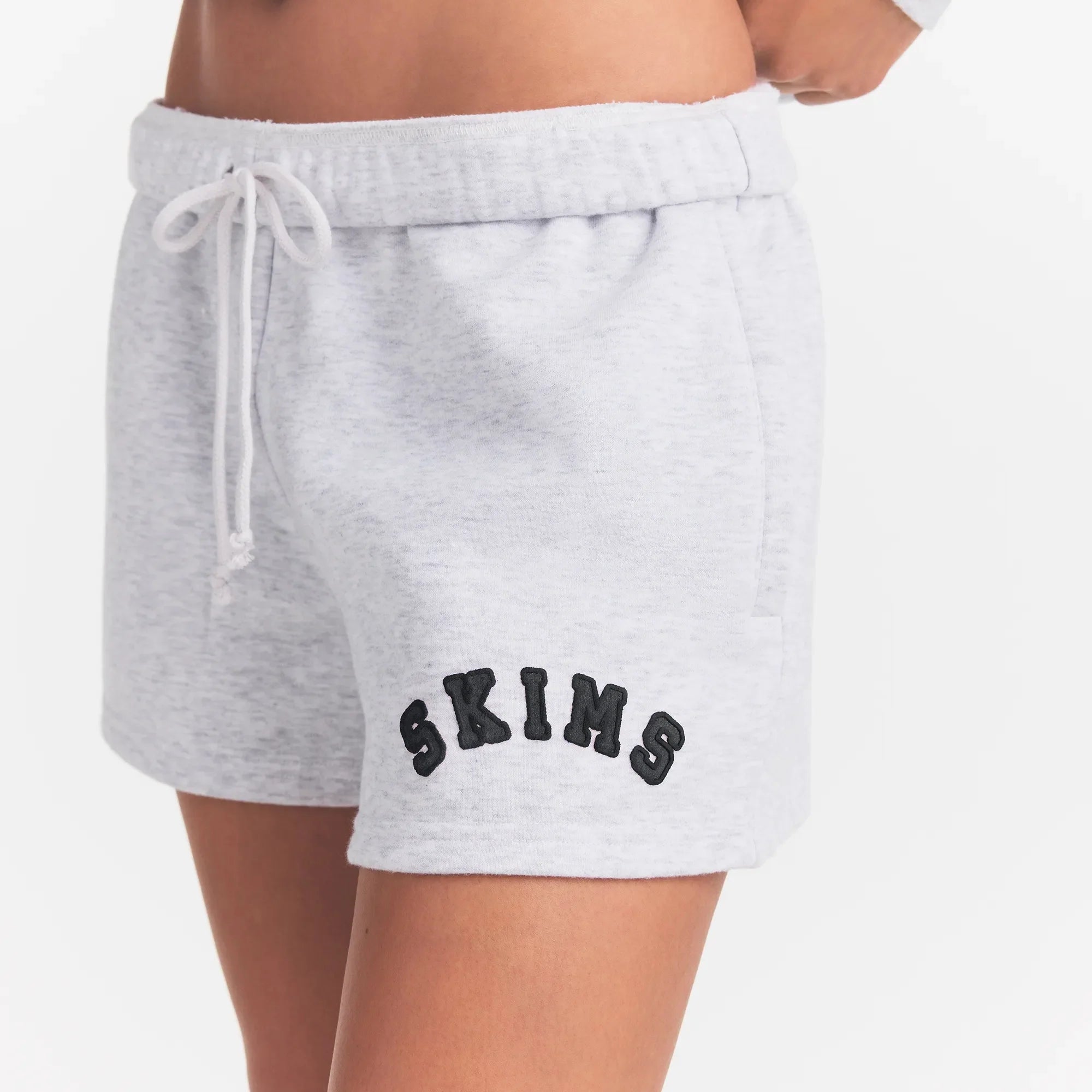 COTTON FLEECE CLASSIC SHORT | LIGHT HEATHER GREY WITH ONYX LOGO ON A MODEL SIDE VIEW @ | FOCUS: 0.0, 1.0, 0.9