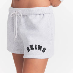 COTTON FLEECE CLASSIC SHORT | LIGHT HEATHER GREY WITH ONYX LOGO ON A MODEL SIDE VIEW @ | FOCUS: 0.0, 1.0, 0.9