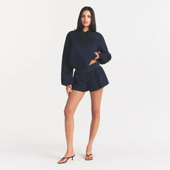 WOVEN COTTON FLUTTER SHORT | NAVY ON A MODEL FRONT VIEW @ | FOCUS: 0.0, 1.0, 0.9