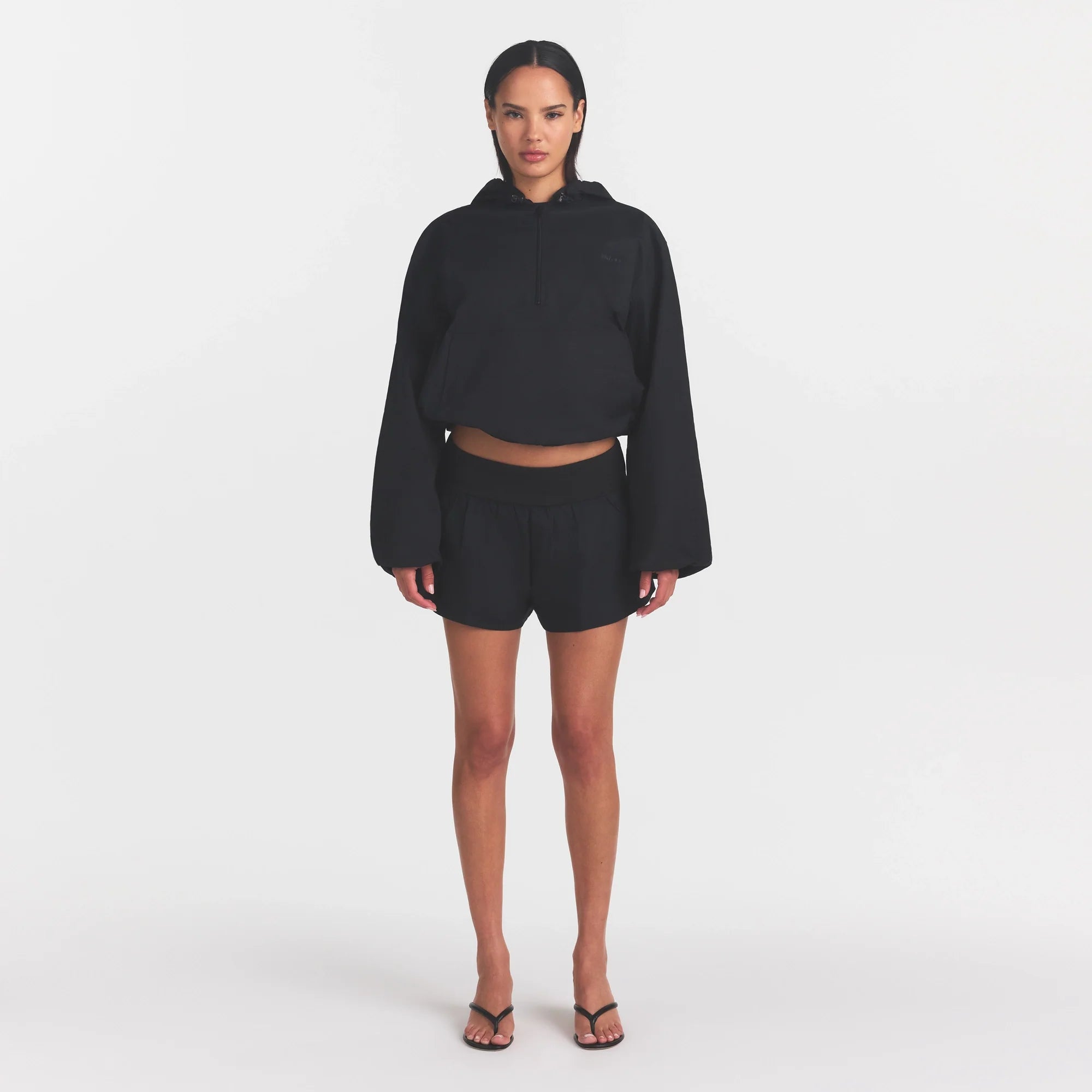 WOVEN COTTON FLUTTER SHORT | ONYX ON A MODEL FRONT VIEW @ | FOCUS: 0.0, 1.0, 0.9