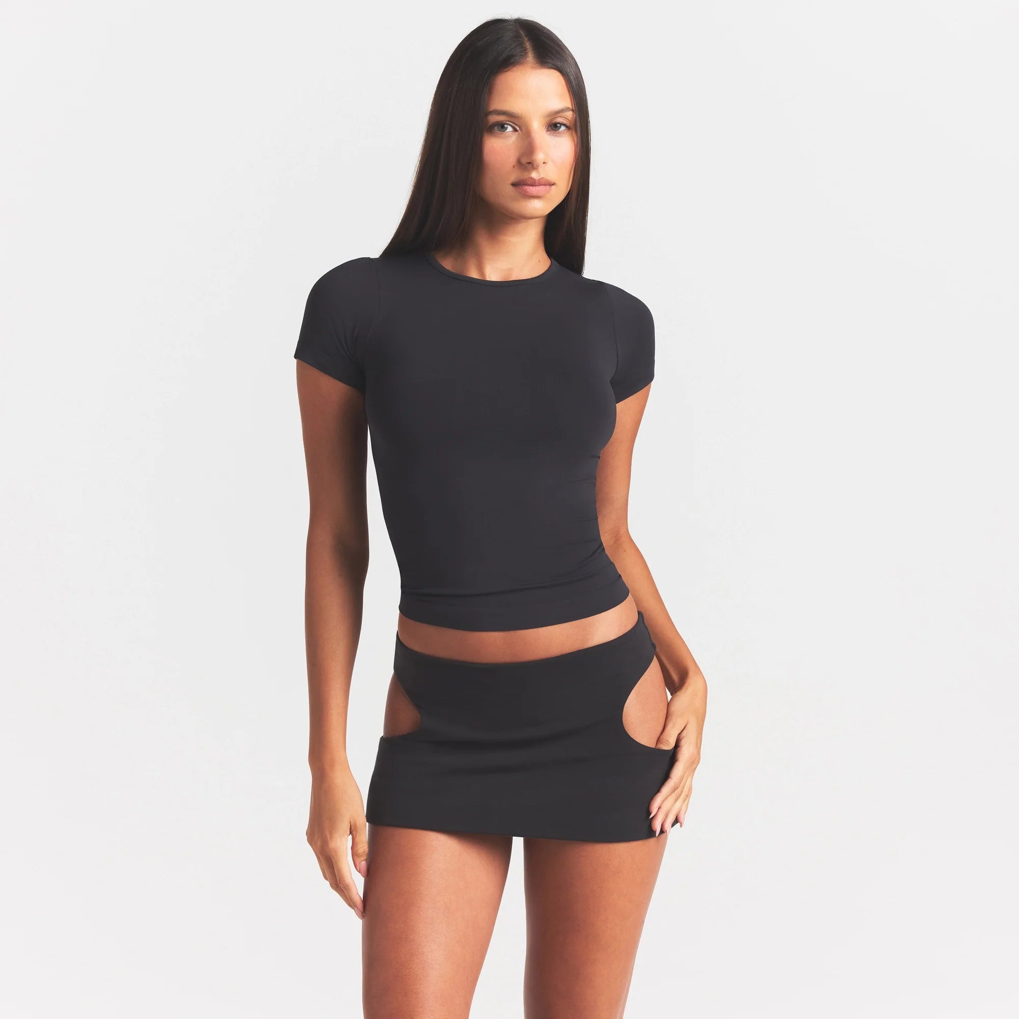 COTTON JERSEY CUT OUT MINI SKIRT | SOOT ON A MODEL SIDE VIEW @ | FOCUS: 0.0, 1.0, 0.9