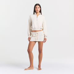 DRAPEY FRENCH TERRY MINI SKIRT | BUFF ON A MODEL FRONT VIEW @ | FOCUS: 0.0, 1.0, 0.9