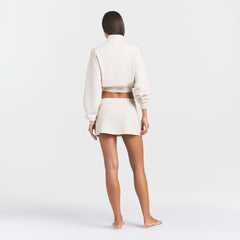 DRAPEY FRENCH TERRY MINI SKIRT | BUFF ON A MODEL SIDE VIEW @ | FOCUS: 0.0, 1.0, 0.9