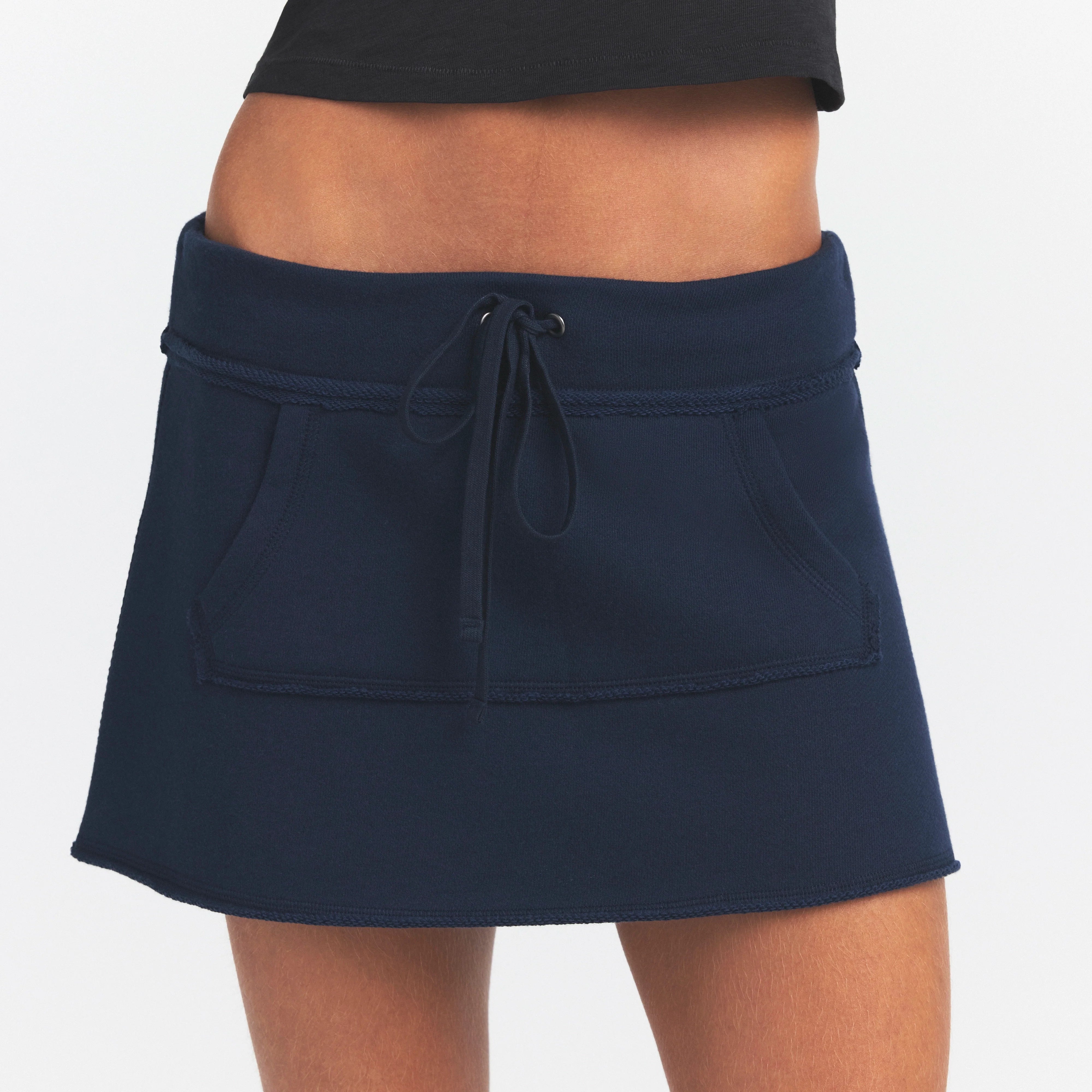 DRAPEY FRENCH TERRY MINI SKIRT | NAVY ON A MODEL SIDE VIEW @ | FOCUS: 0.0, 1.0, 0.9