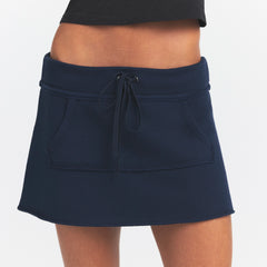 DRAPEY FRENCH TERRY MINI SKIRT | NAVY ON A MODEL SIDE VIEW @ | FOCUS: 0.0, 1.0, 0.9