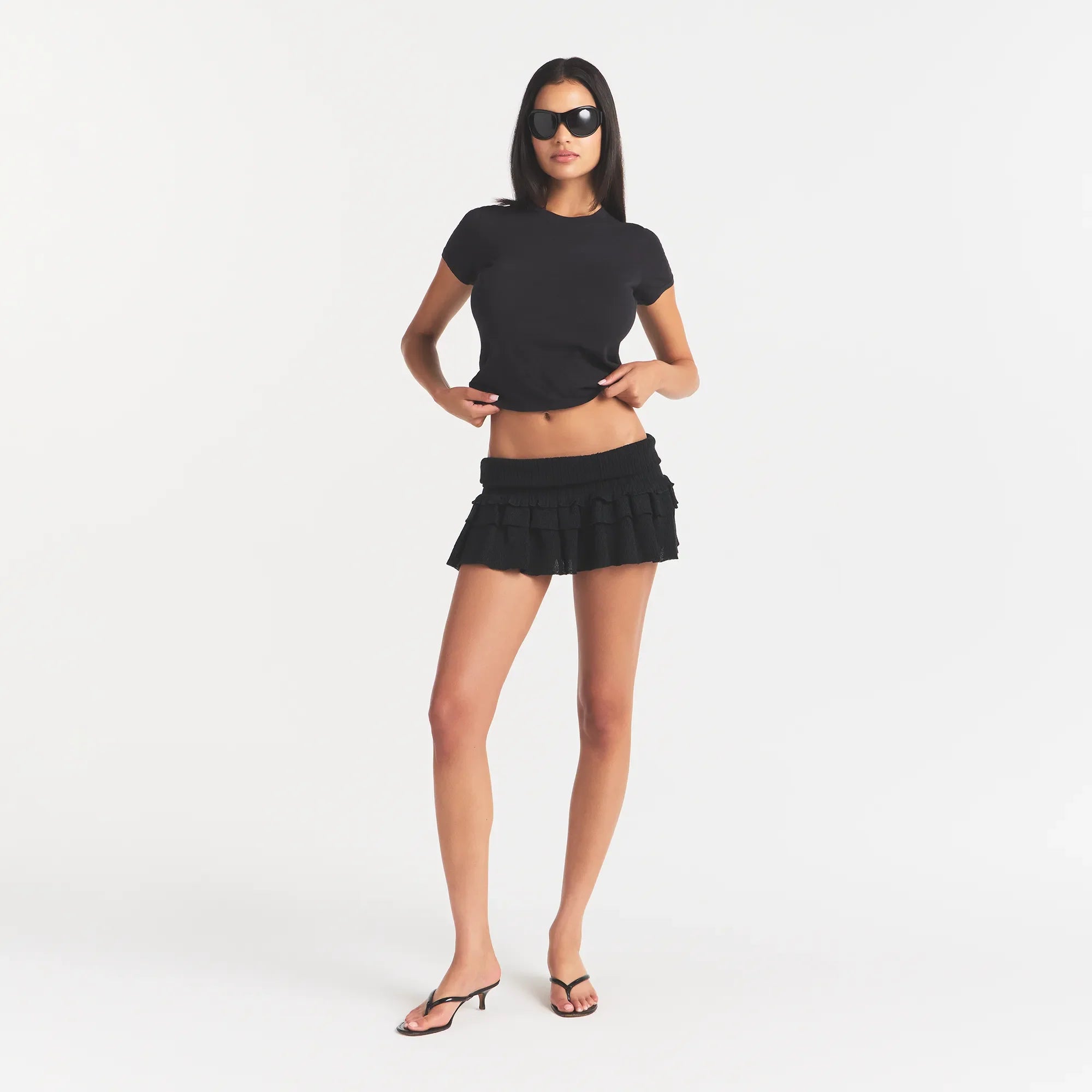 SHEER KNIT RUFFLE MINI SKIRT | ONYX ON A MODEL FRONT VIEW @ | FOCUS: 0.0, 1.0, 0.9