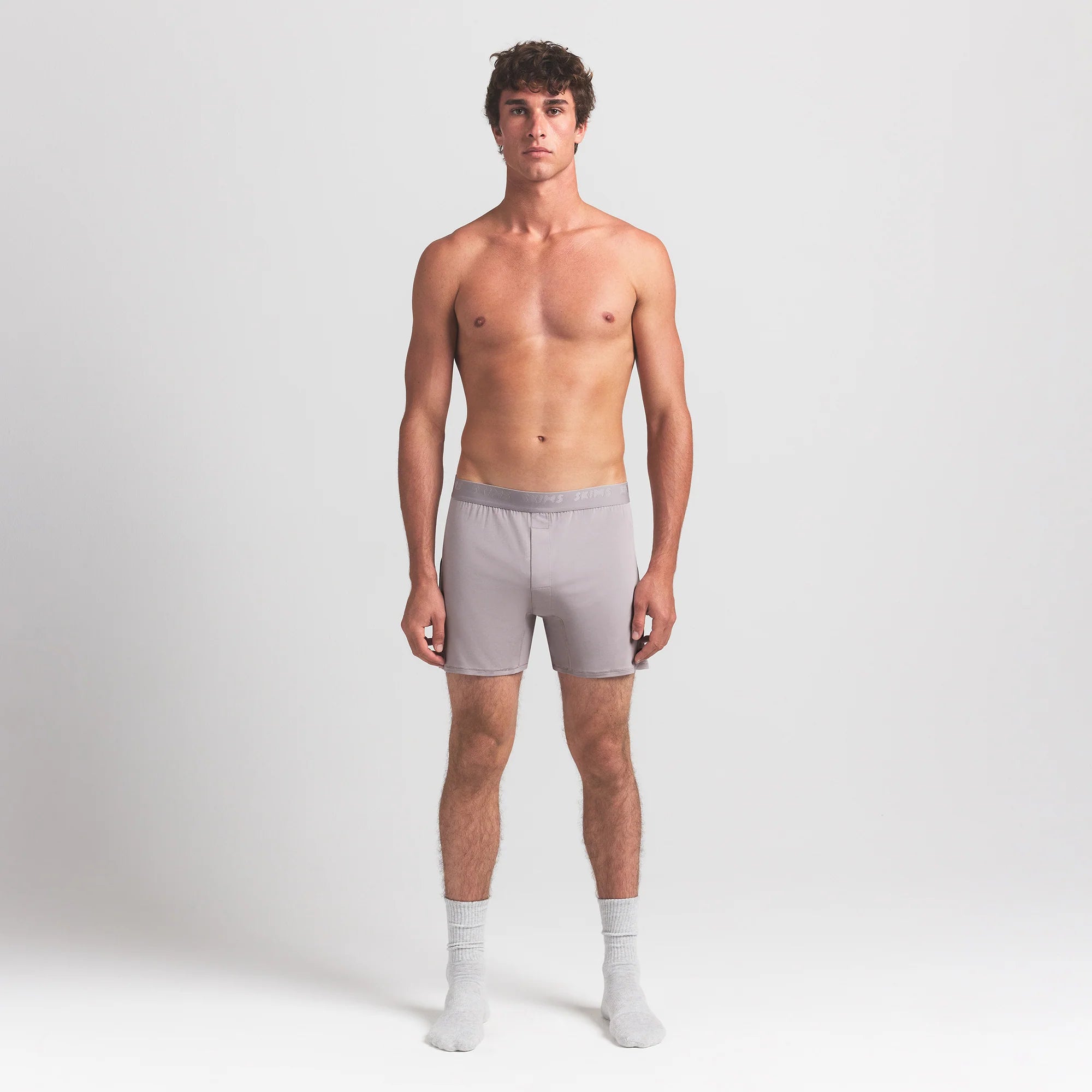 SKIMS STRETCH MENS KNIT BOXER | OYSTER ON A MODEL FRONT VIEW @ | FOCUS: 0.0, 1.0, 0.9