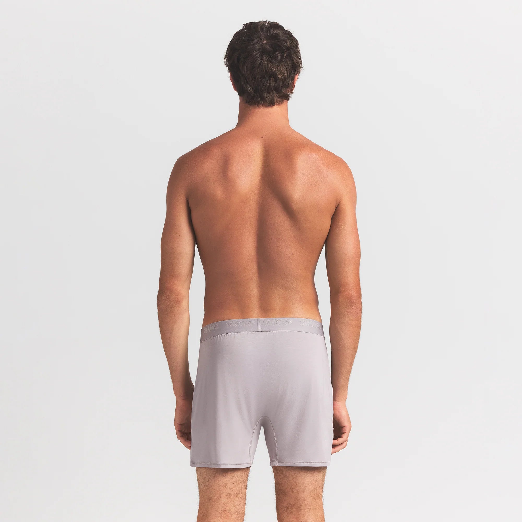 SKIMS STRETCH MENS KNIT BOXER | OYSTER ON A MODEL BACK VIEW @ | FOCUS: 0.0, 1.0, 0.9