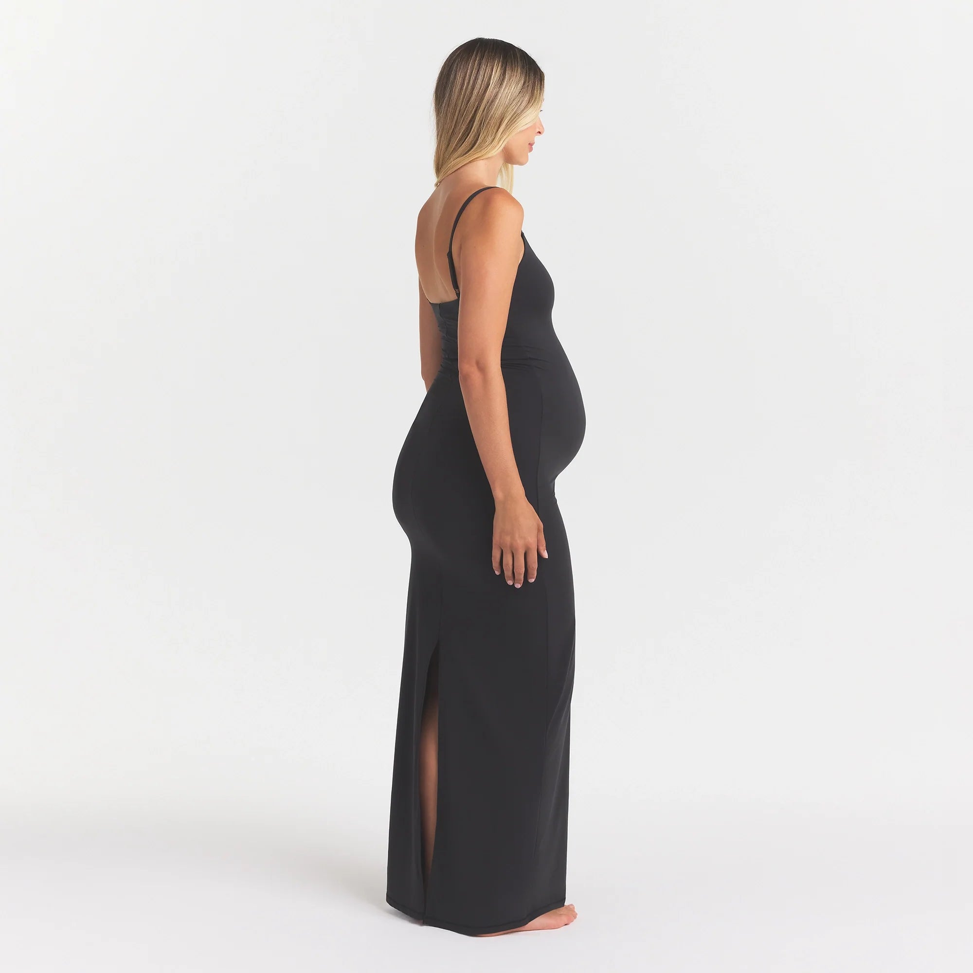 FITS EVERYBODY MATERNITY LONG SLIP DRESS | ONYX ON A MODEL SIDE VIEW @ | FOCUS: 0.0, 1.0, 0.9