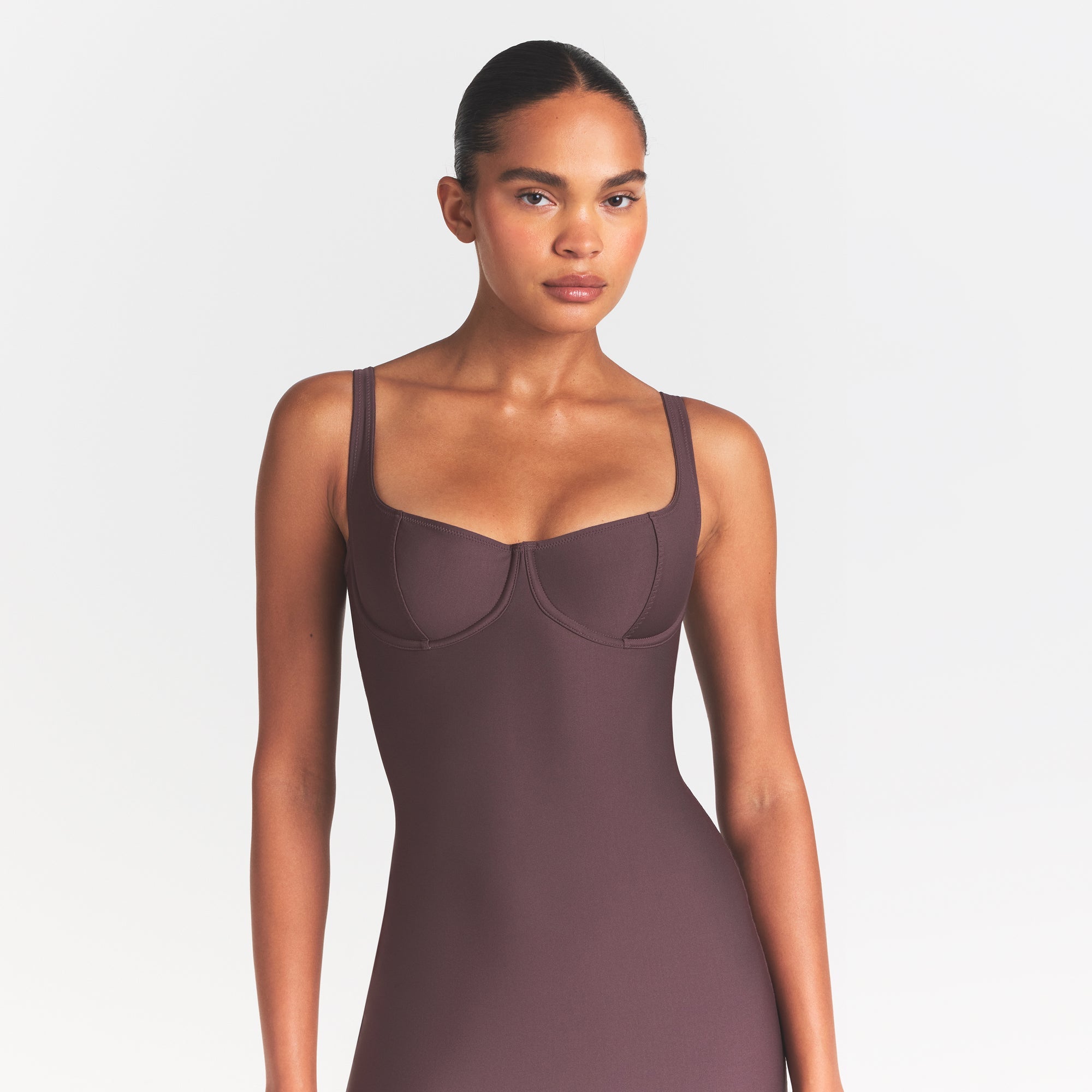 SKIMS BODY MIDI DRESS | RAISIN ON A MODEL SIDE VIEW @